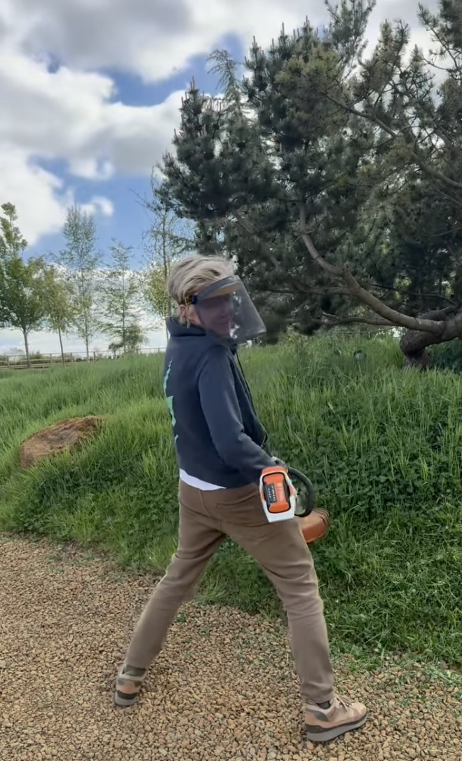 Ellen DeGeneres cuts some grass at home in a video she shared on May 8, 2025 | Source: Instagram/ellendegeneres