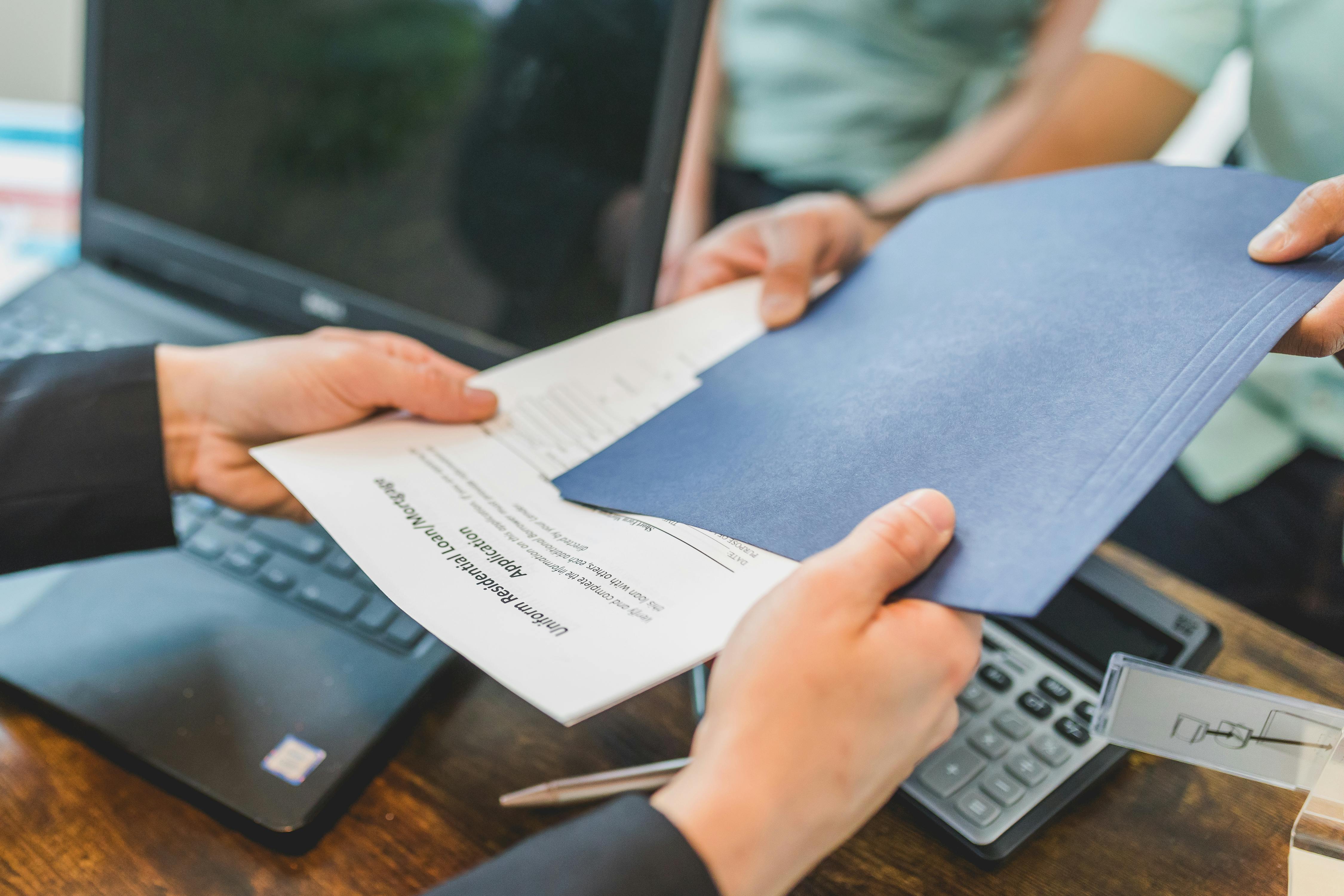People holding documents | Source: Pexels