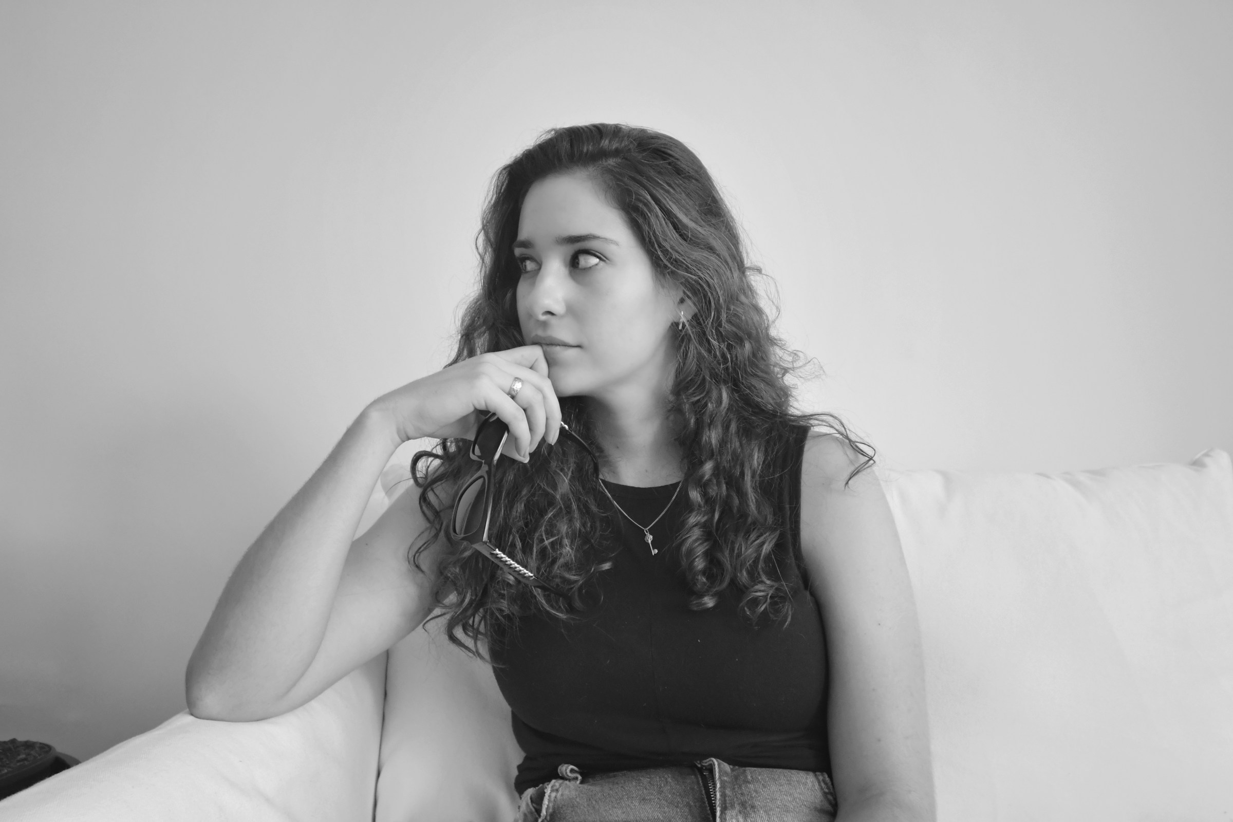 A grayscale photo of a thoughtful woman | Source: Unsplash