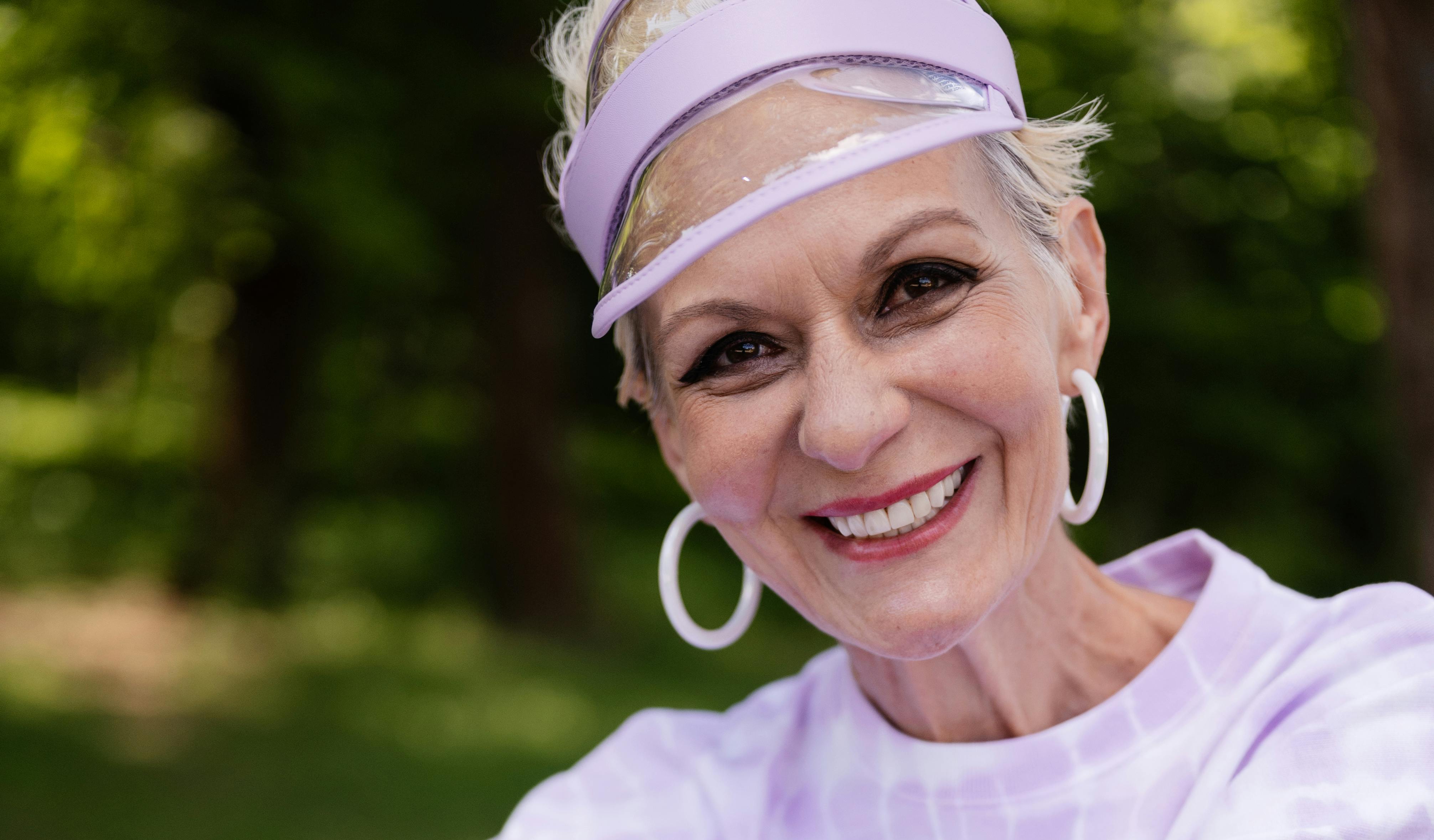 An older woman smiling outdoors | Source: Pexels