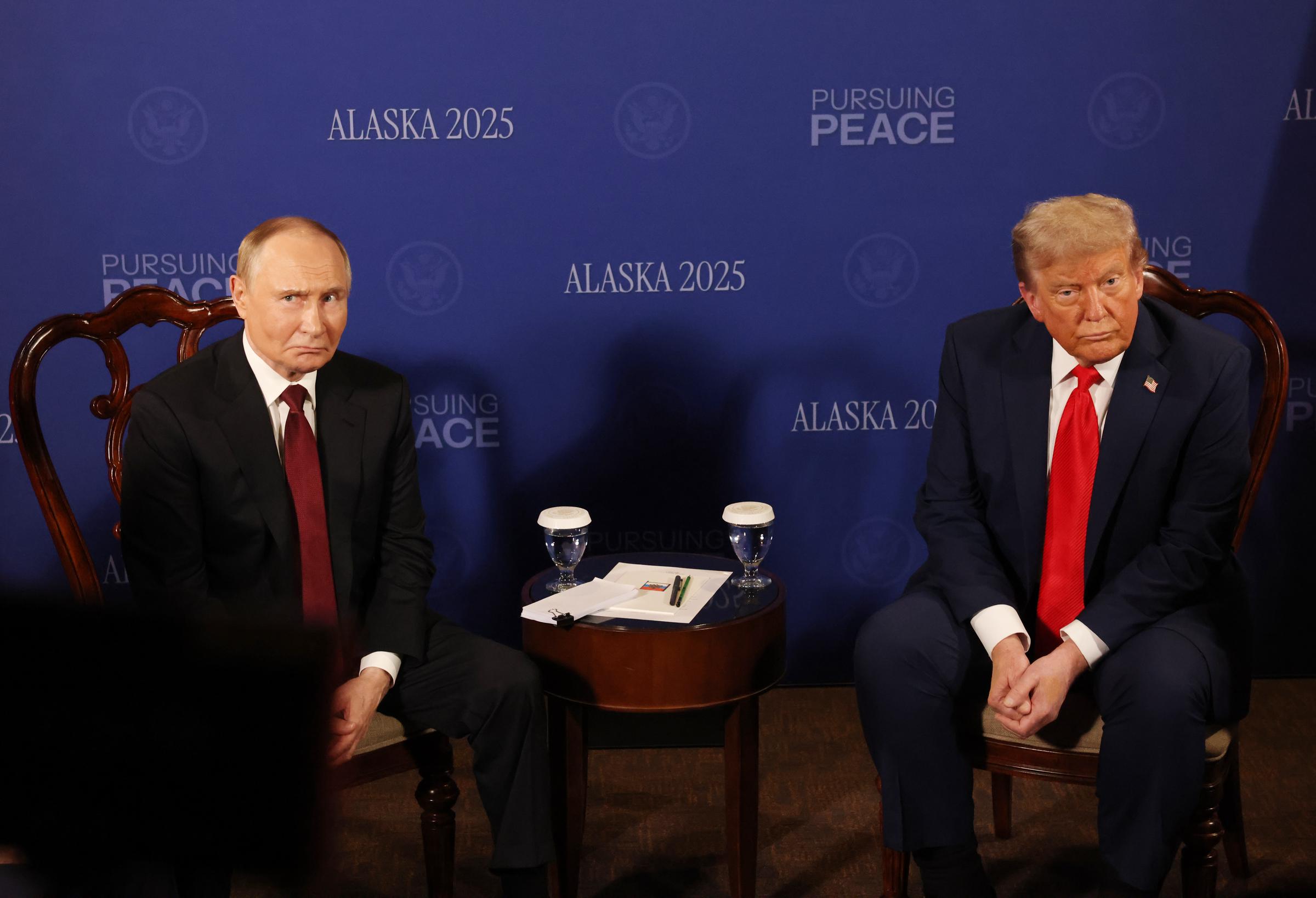 Russian President Vladimir Putin (L)looks on as U.S. President Donald Trump (R) reacts during their meeting on war in Ukraine at Joint Base Elmendorf-Richardson on August 15, 2025, in Anchorage, Alaska. | Source: Getty Images