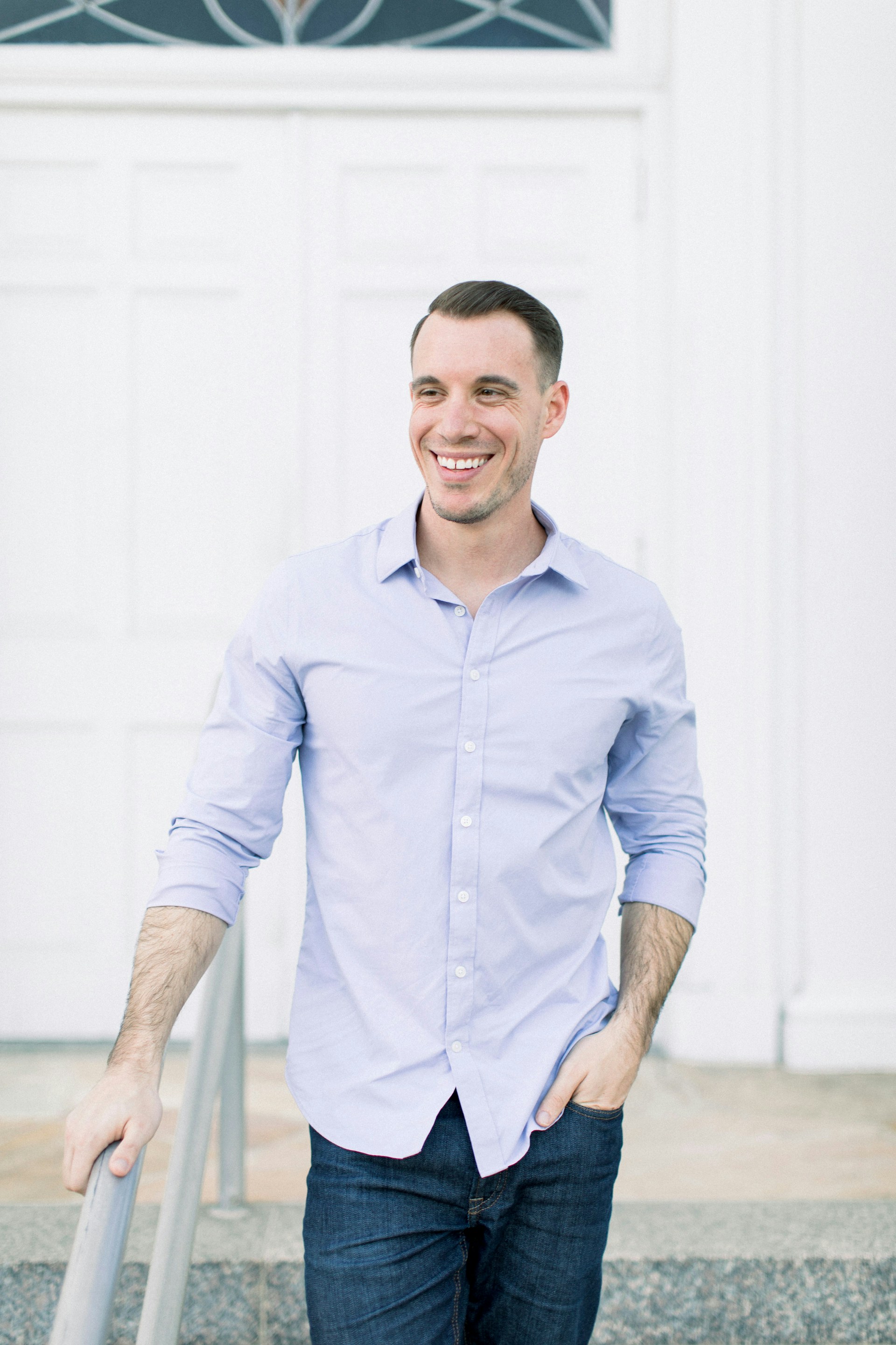 A grinning man standing near a front door | Source: Unsplash