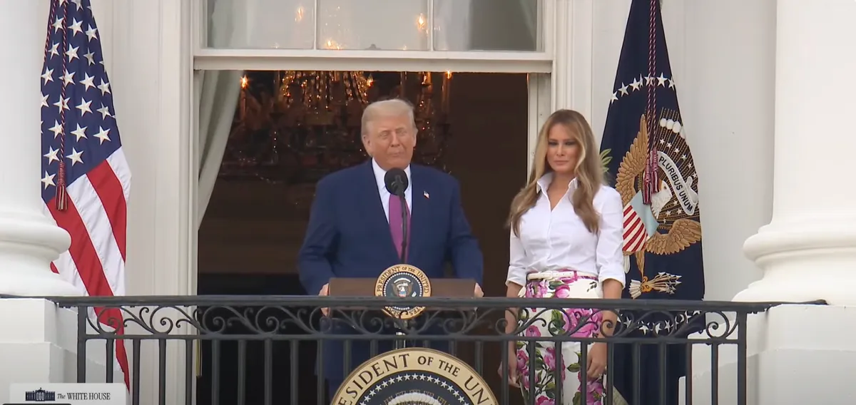 First Lady Melania Trump smiles as President Donald Trump delivers his speech on the Truman Balcony at the White House on June 12, 2025 | Source: YouTube/The White House