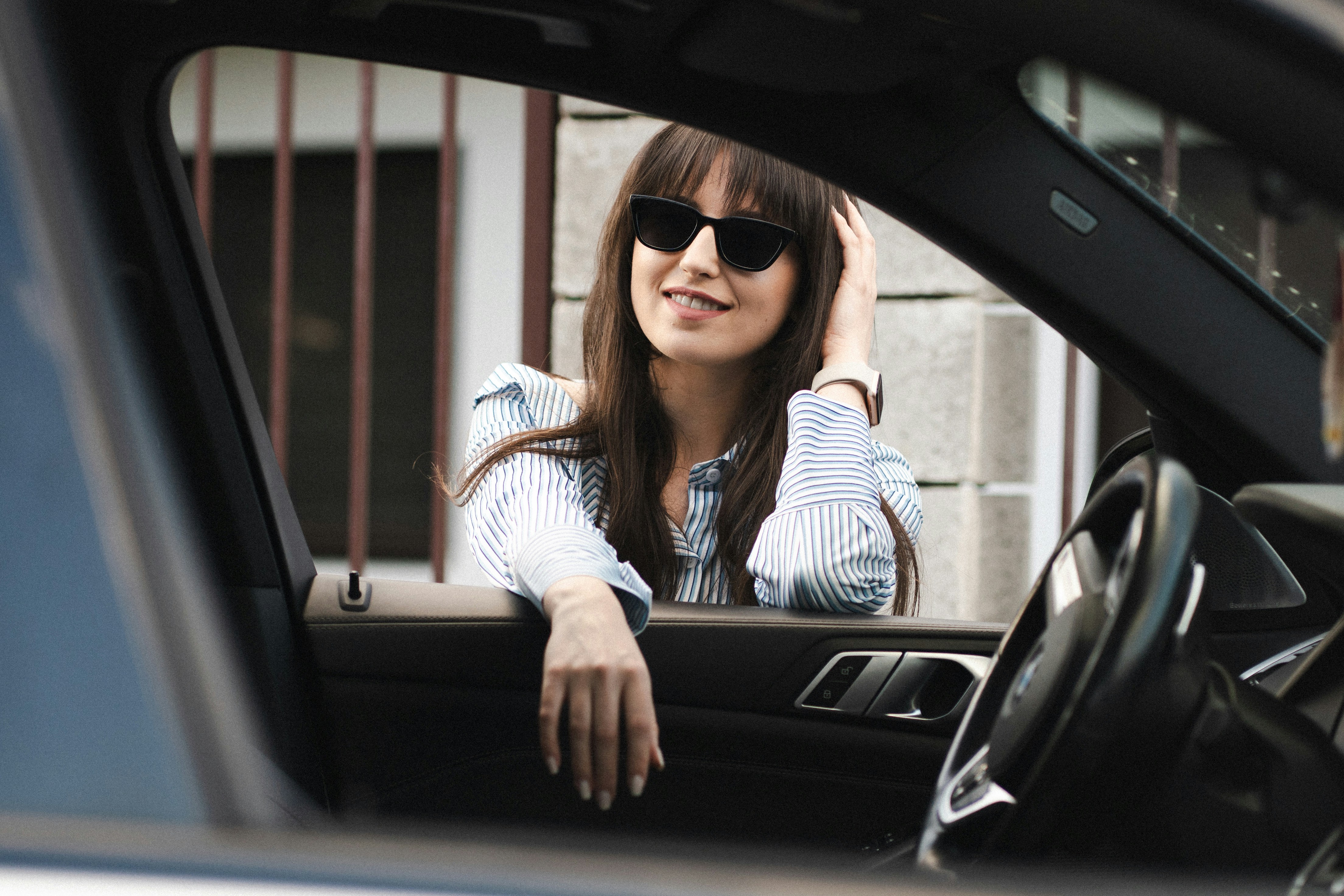 A woman leaning into a car | Source: Unsplash