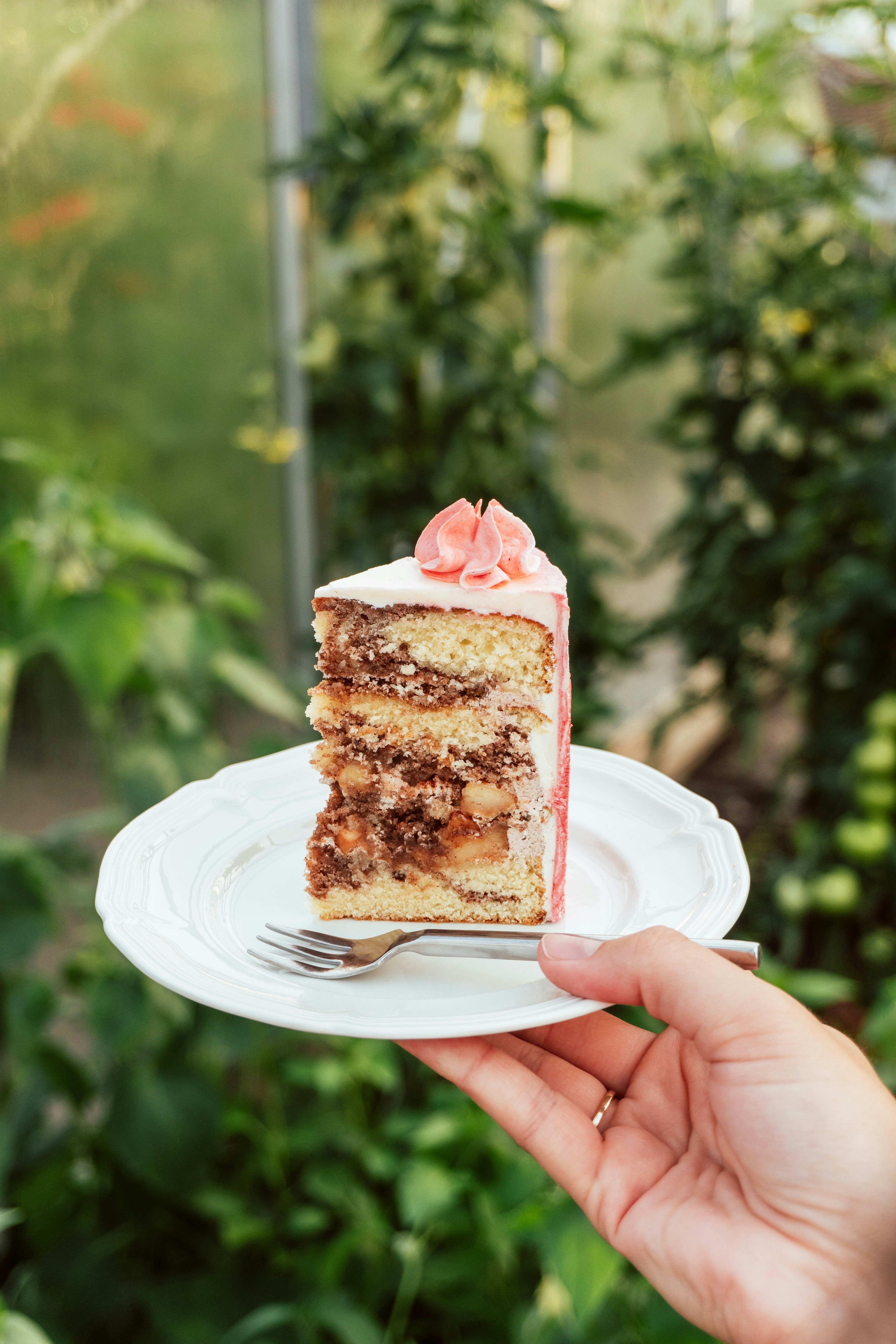 My MIL Demanded I Leave My Own Home During the Birthday Party I Organized for Her – She Didn't Know How Big a Mistake That Was 19 A person holding a slice of cake | Source: Unsplash