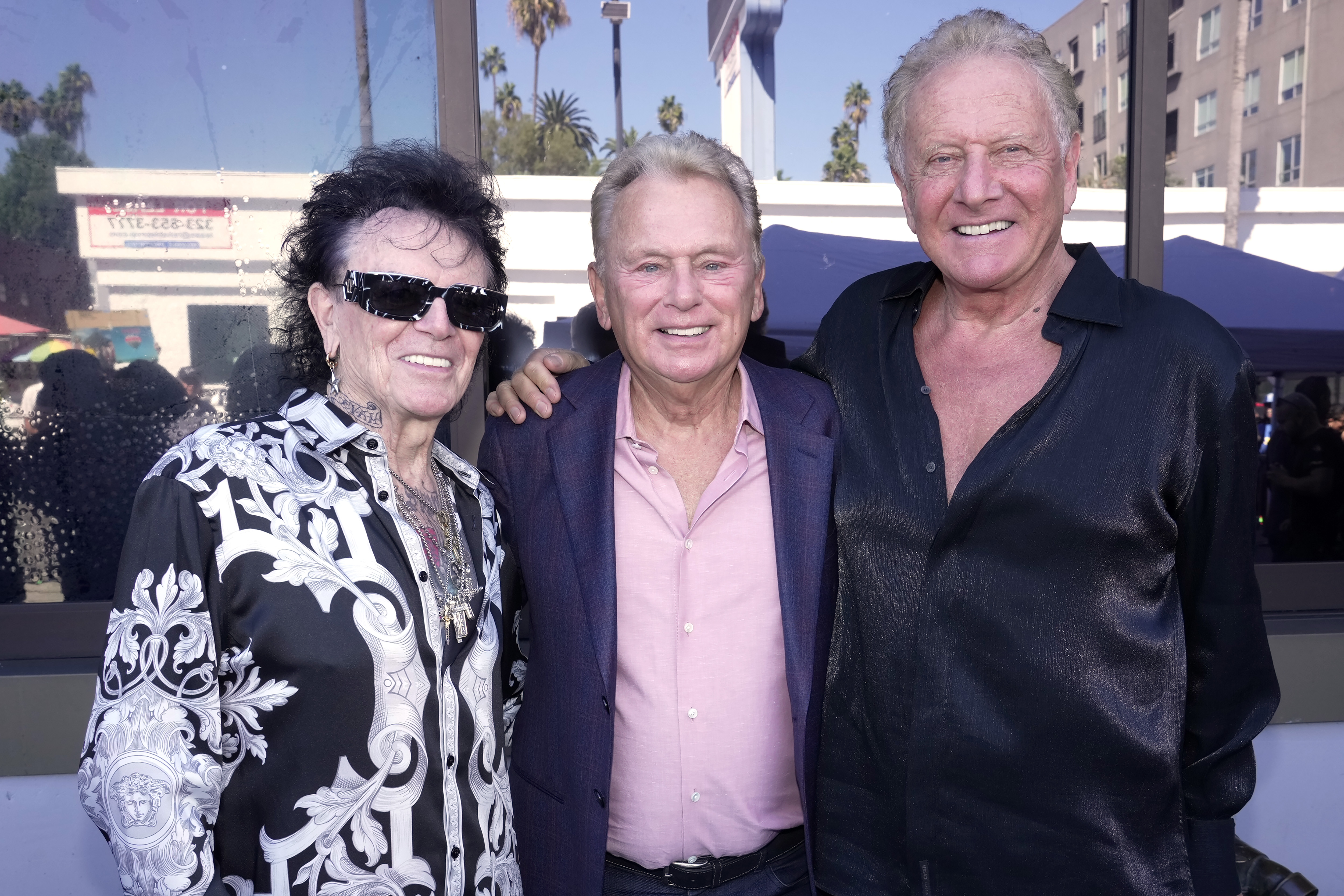 Pat Sajak (center) poses with honorees Russell Hitchcock and Graham Russell of Air Supply as the duo received their star on the Hollywood Walk of Fame on October 8, 2026 | Source: Getty Images