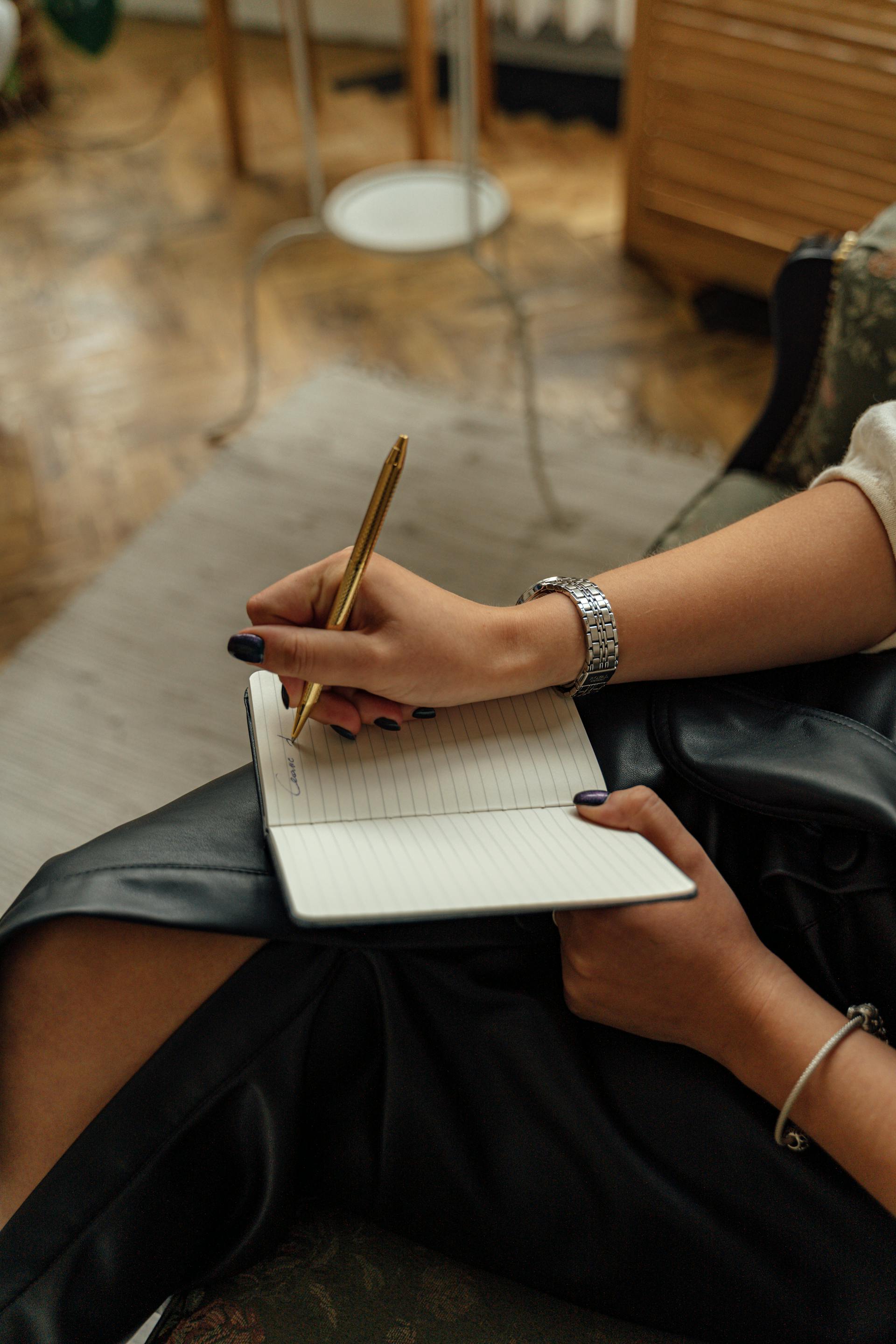 A close-up shot of a woman writing on a notebook | Source: Pexels