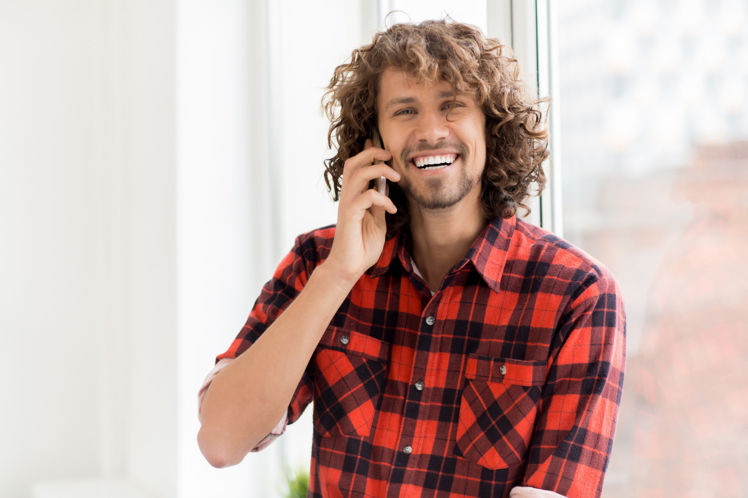 A laughing man talking on the phone | Source: Freepik