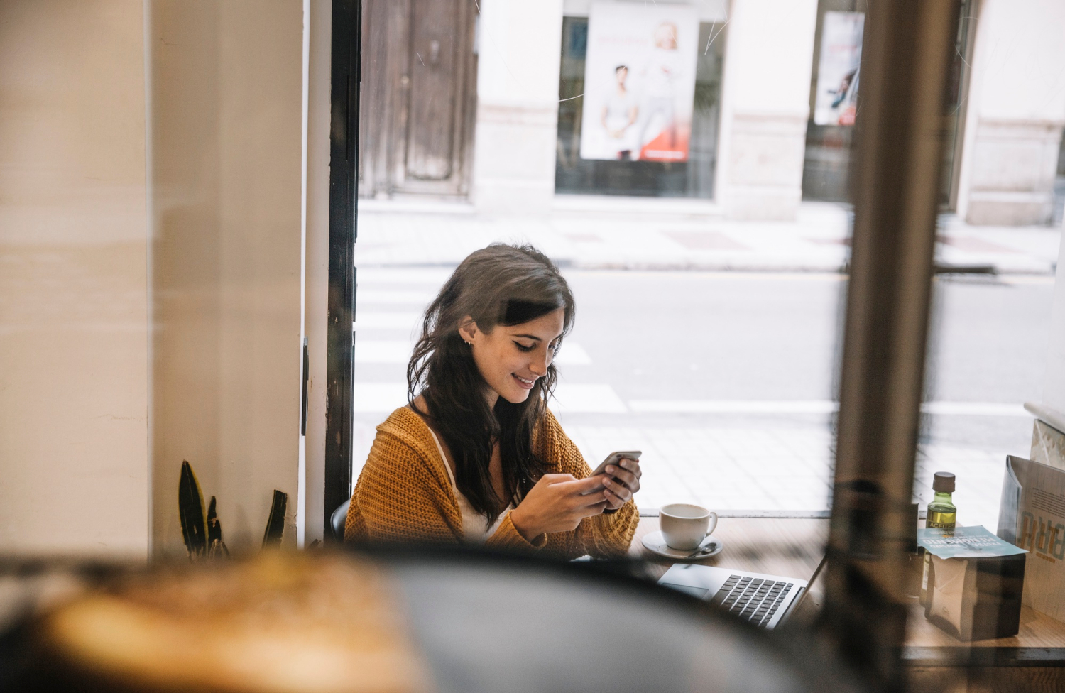 A woman looking at her phone and smiling | Source: Freepik