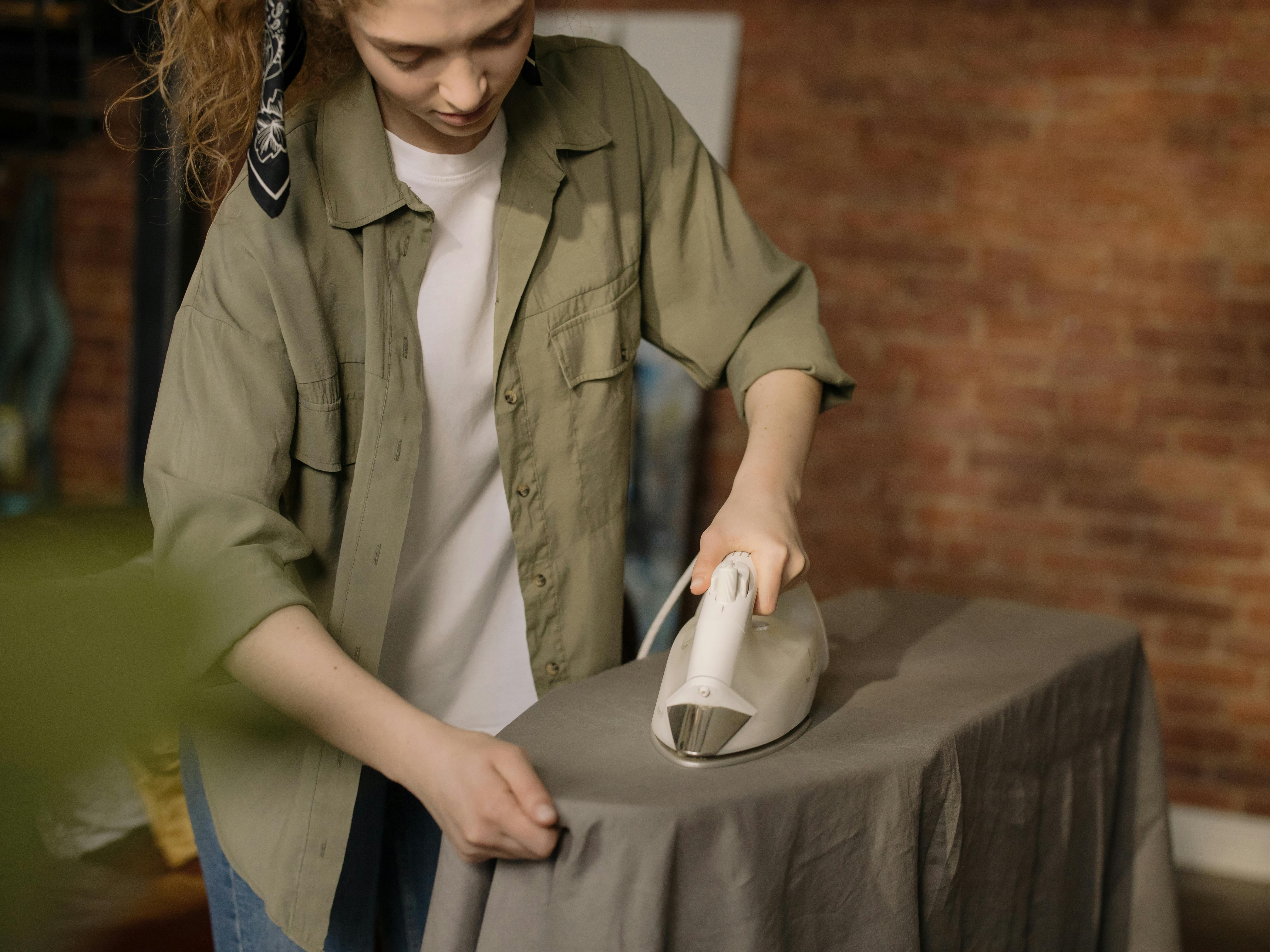 Woman ironing clothes | Source: Pexels