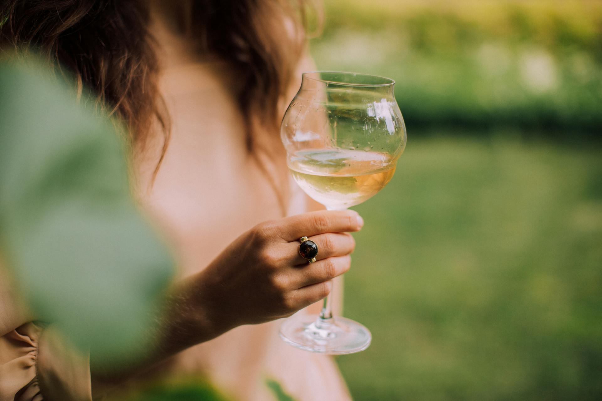 A woman holding a glass of wine | Source: Pexels