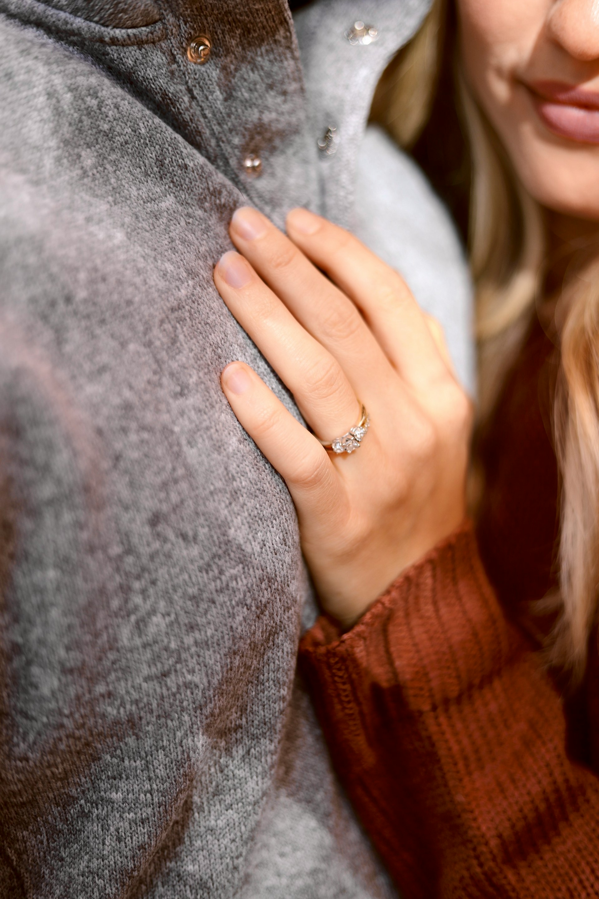 A delighted woman embracing her partner while flaunting her engagement ring | Source: Unsplash