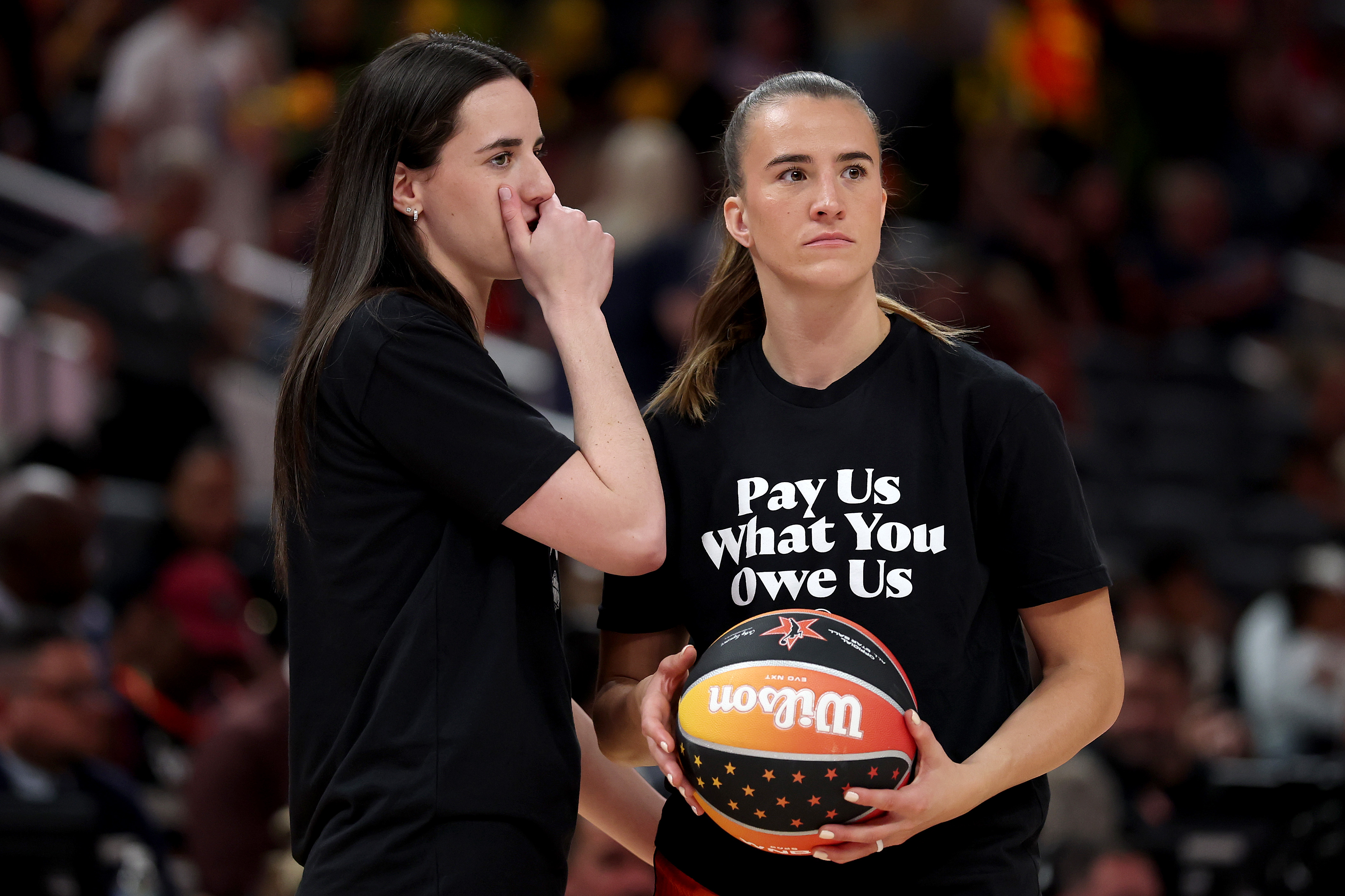 Caitlin Clark of the Indiana Fever and Sabrina Ionescu of the New York Liberty prior to the 2025 AT&T WNBA All-Star Game at Gainbridge Fieldhouse on July 19, 2025 in Indianapolis, Indiana. | Source: Getty Images