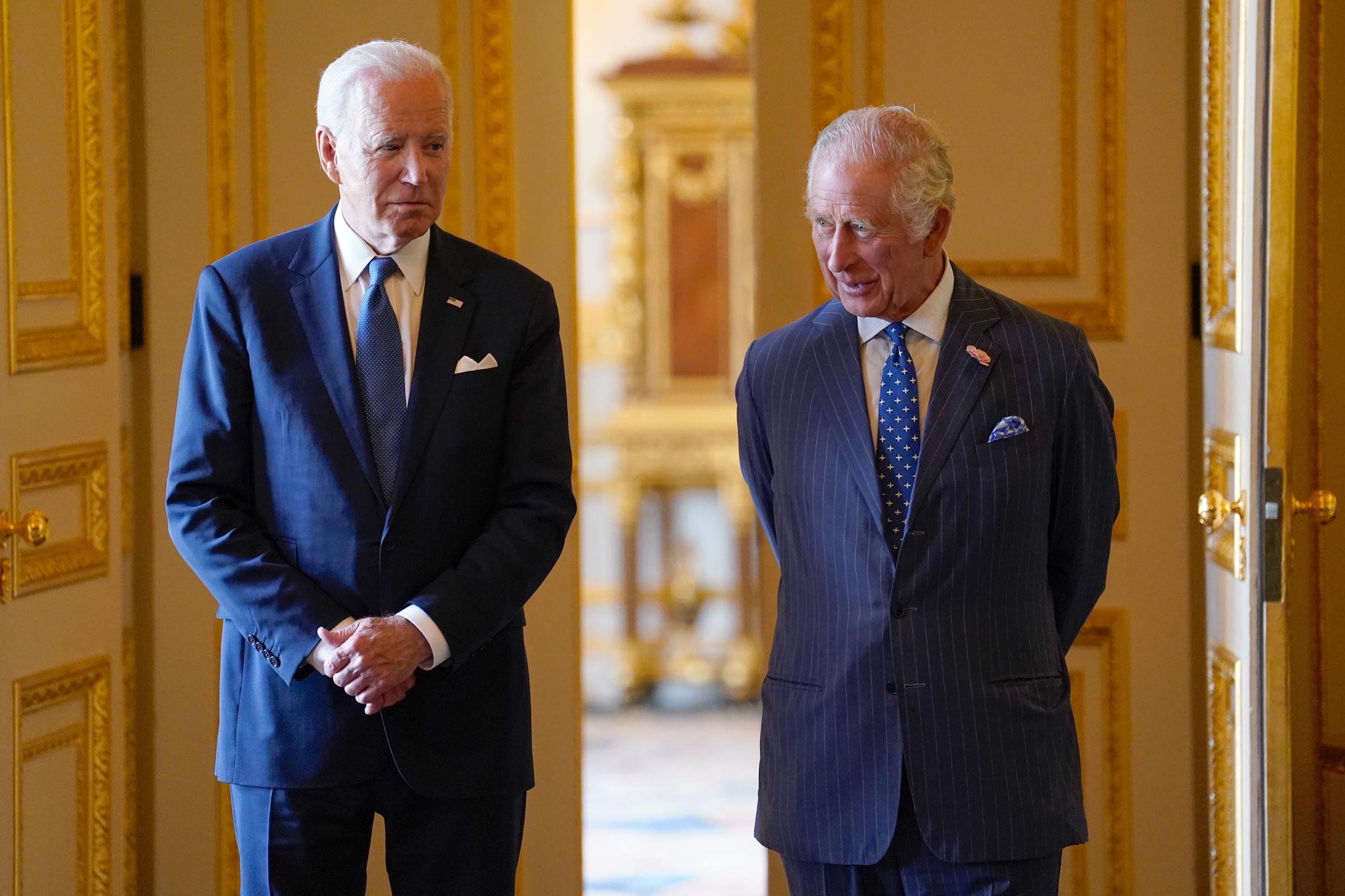 King Charles III and US President Joe Biden arrive to meet participants of the Climate Finance Mobilisation forum in the Green Drawing Room at Windsor Castle on July 10, 2023, in Windsor, England. | Source: Getty Images