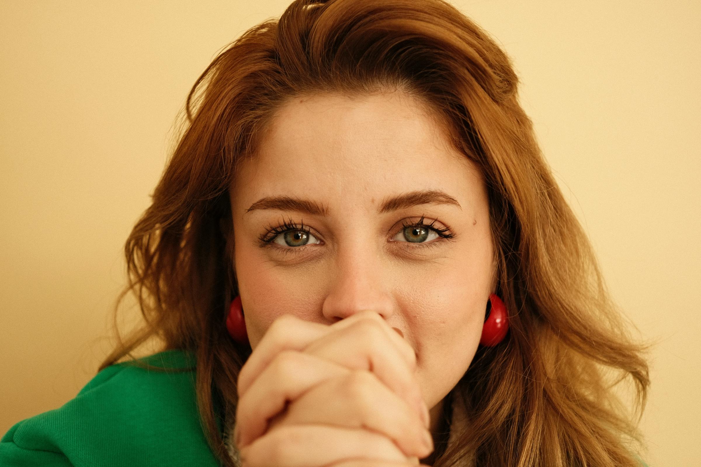 Photo Creditor - Pexels Custom Gem This is for informational purposes only. For medical advice or diagnosis, consult a professional. A young woman grinning while clasping her hands | Source: Pexels