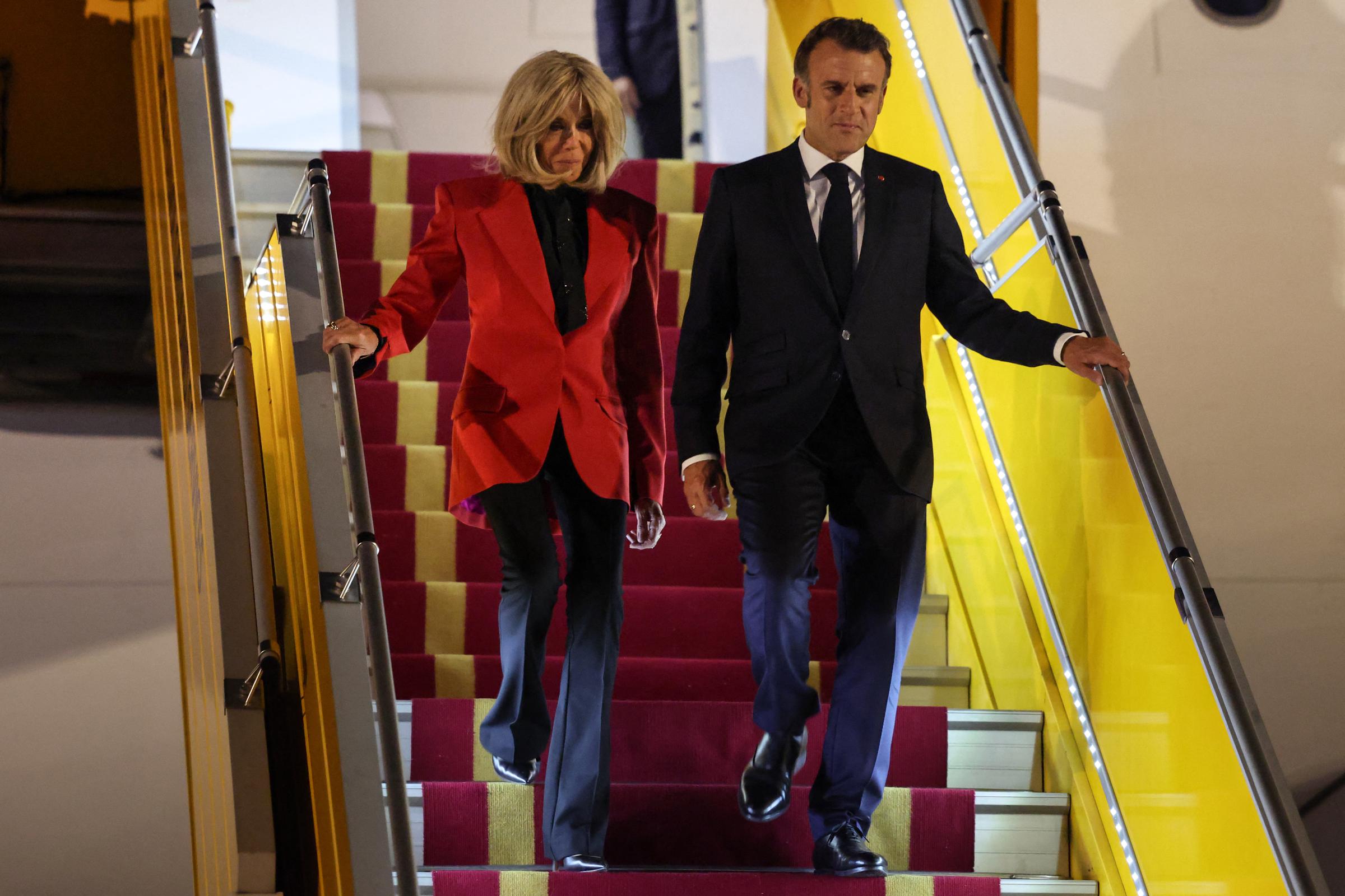 France's President Emmanuel Macron and his wife Brigitte Macron disembark from the plane upon their arrival at Noi Bai International Airport in Hanoi on May 25, 2025. | Source: Getty Images