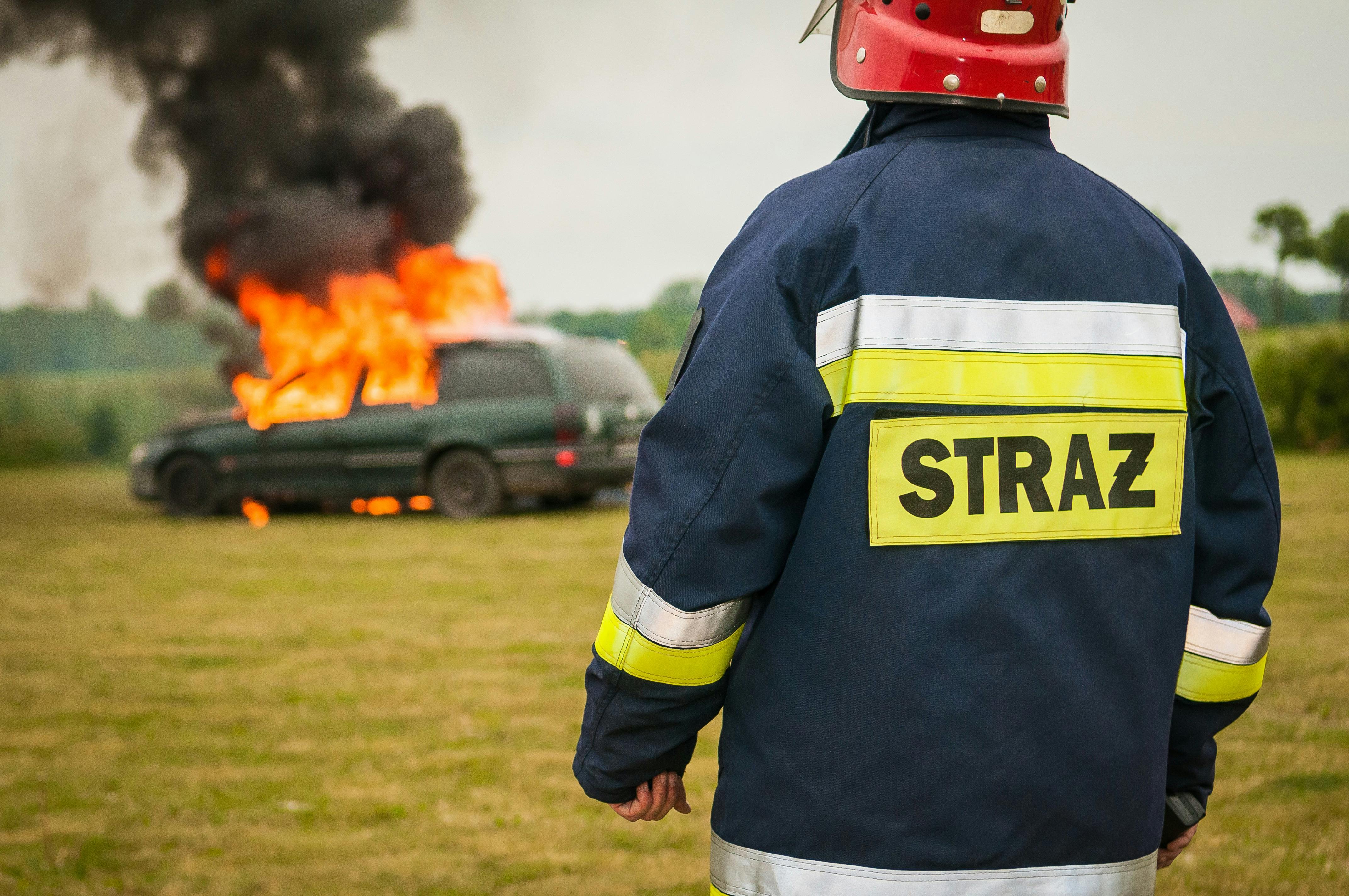 A fireman looks on as a car burns | Source: Pexels