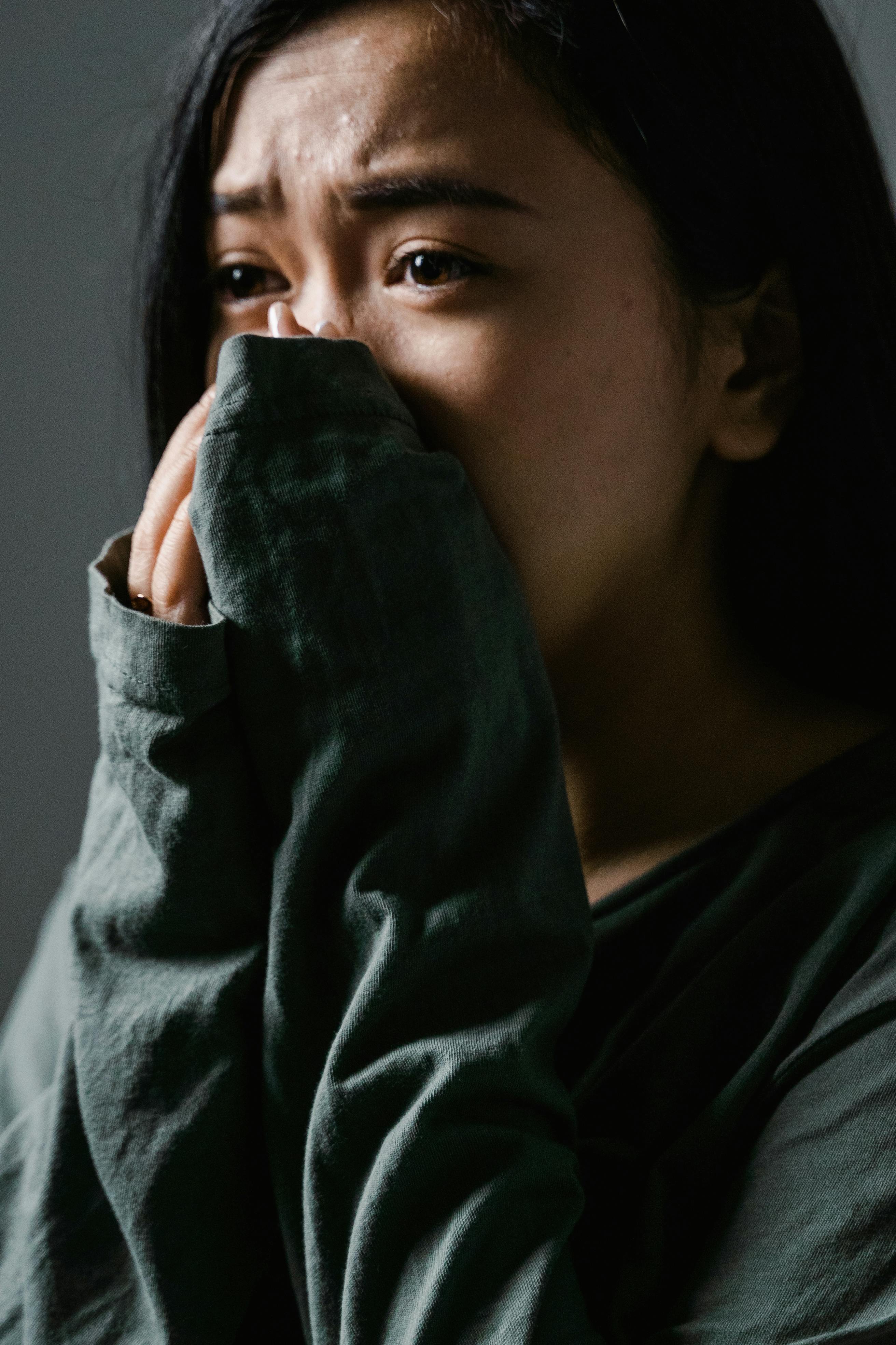 A woman covering her mouth with her hands | Source: Pexels