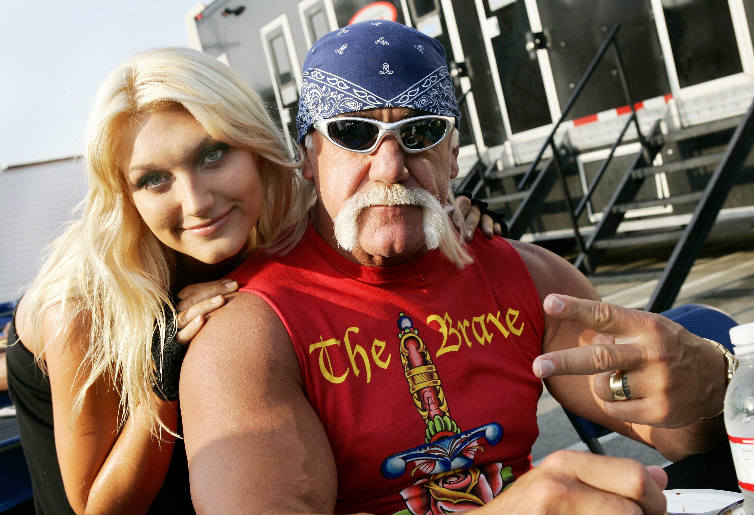 Hulk Hogan (R) poses with daughter Brooke Hohan on the set of her music video shoot for her song, 'Bout Us,' on May 6, 2006, in Los Angeles, California. | Source: Getty Images
