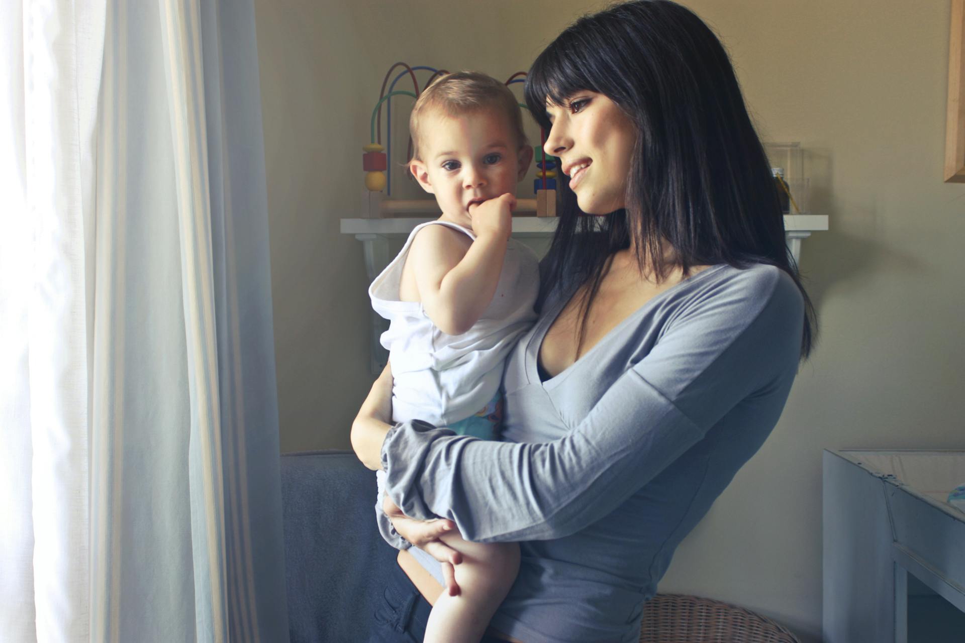 A woman holding a baby | Source: Pexels
