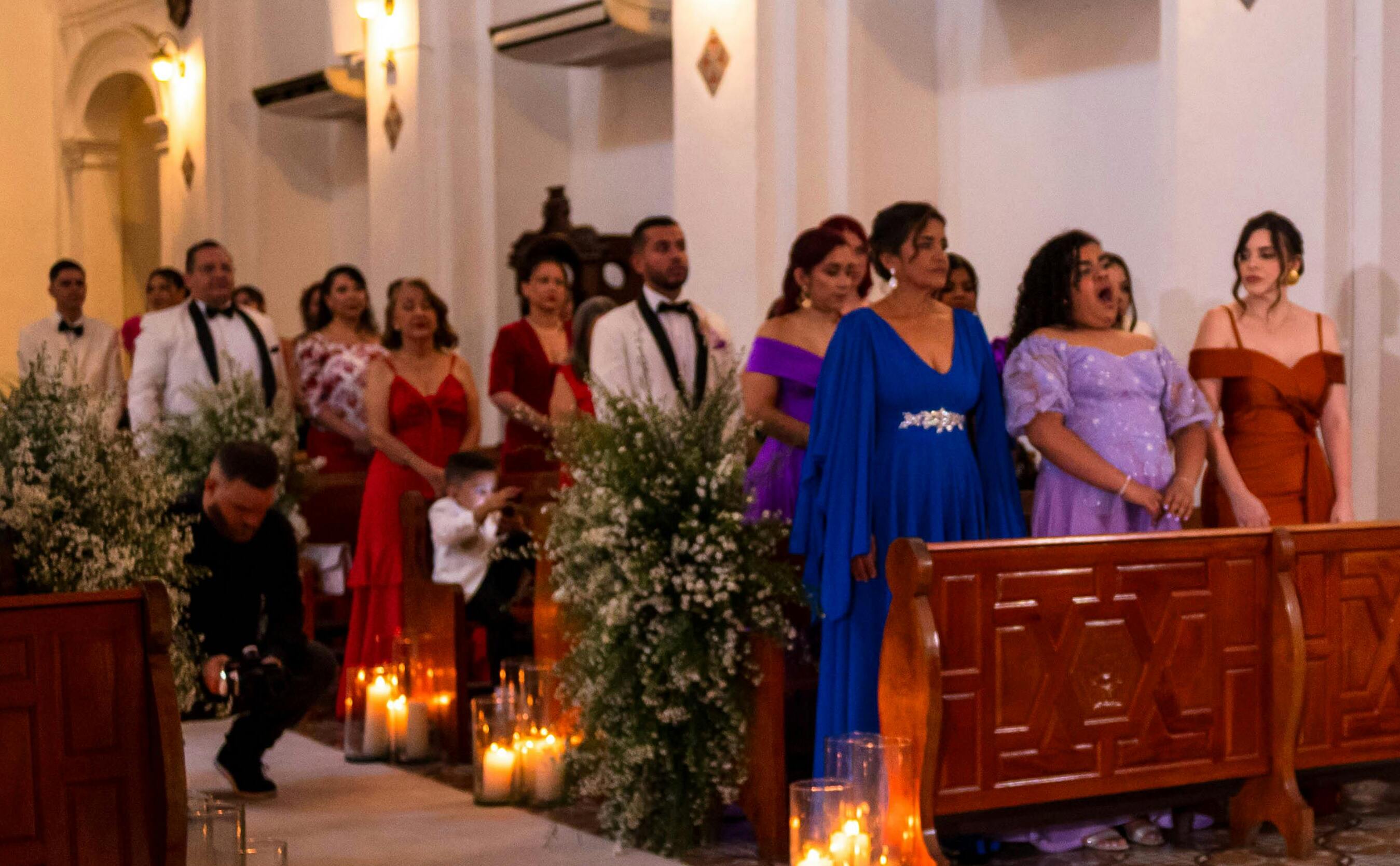 Wedding guests standing by the pews | Source: Pexels