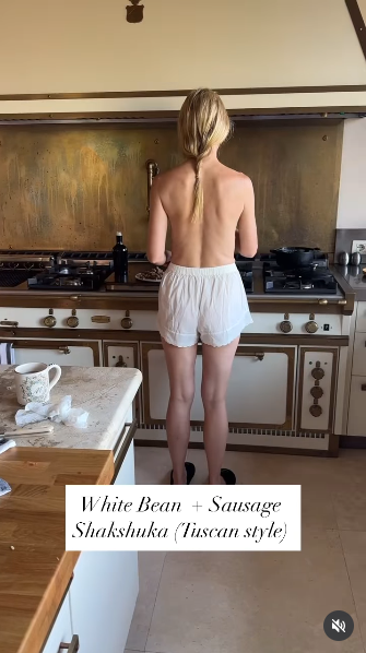 Gwyneth Paltrow appearing topless as she prepares breakfast in a sunlit kitchen, her back turned away from the camera while she cooks posted from a video dated June 14, 2025 | Source: Instagram/gwynethpaltrow