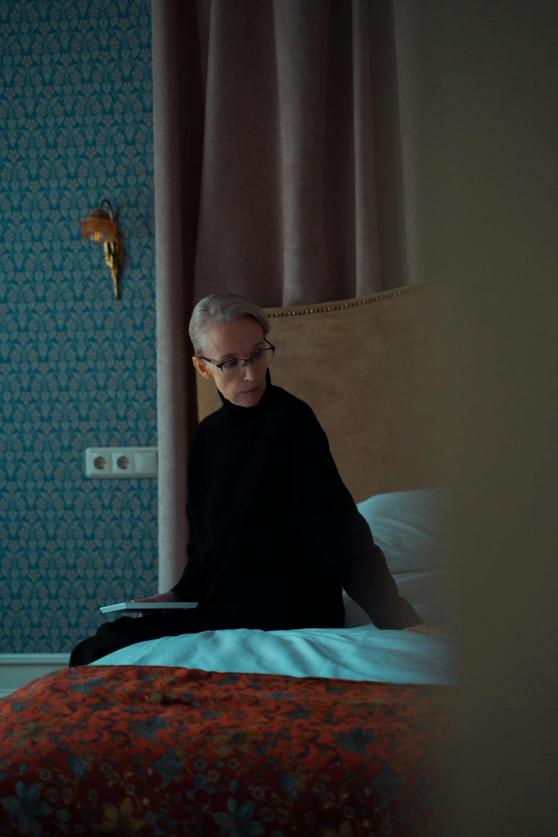 A thoughtful woman sitting on a bed | Source: Pexels