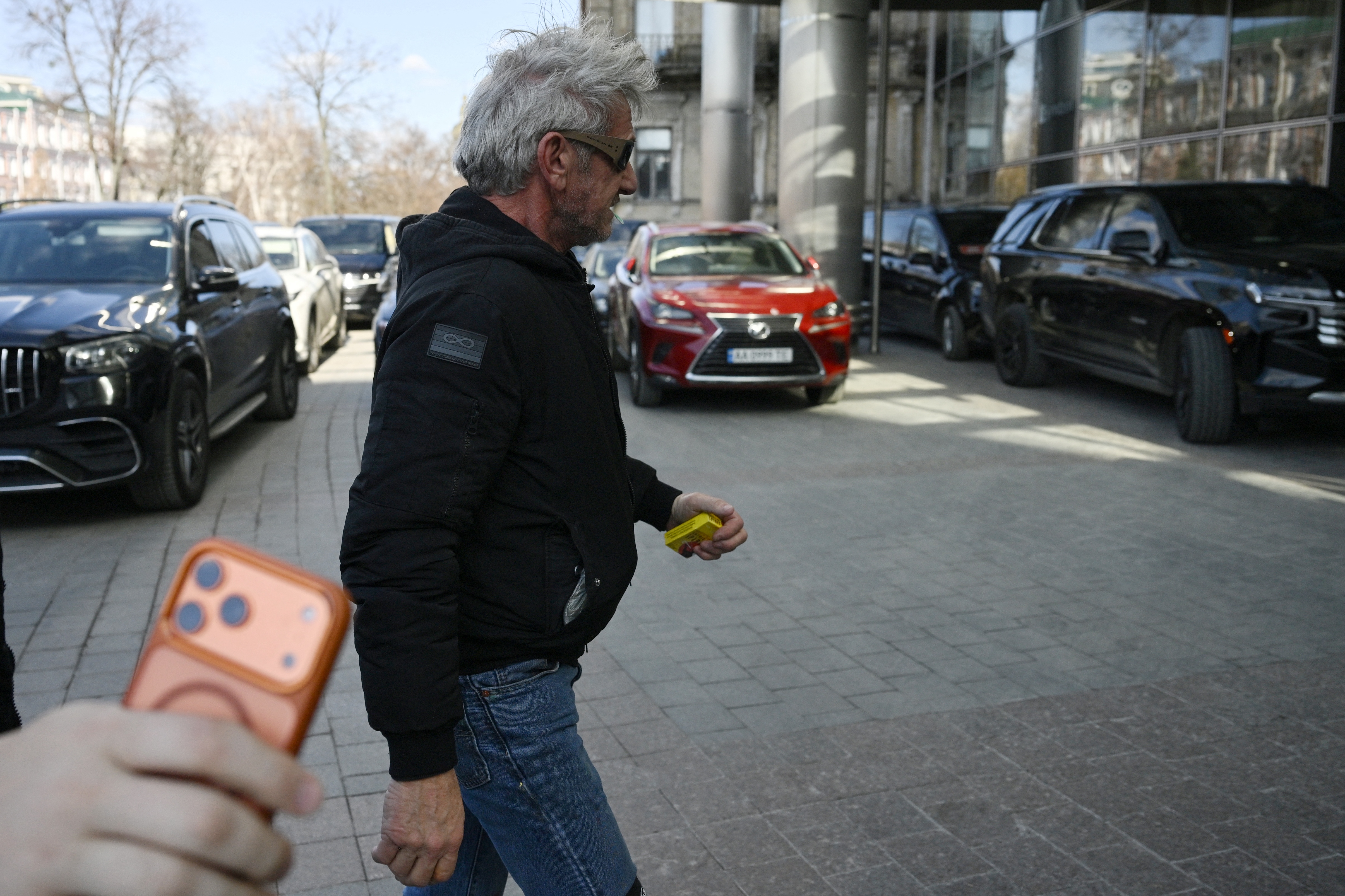 Sean Penn walks down a street in Kyiv on March 16, 2026. | Source: Getty Images