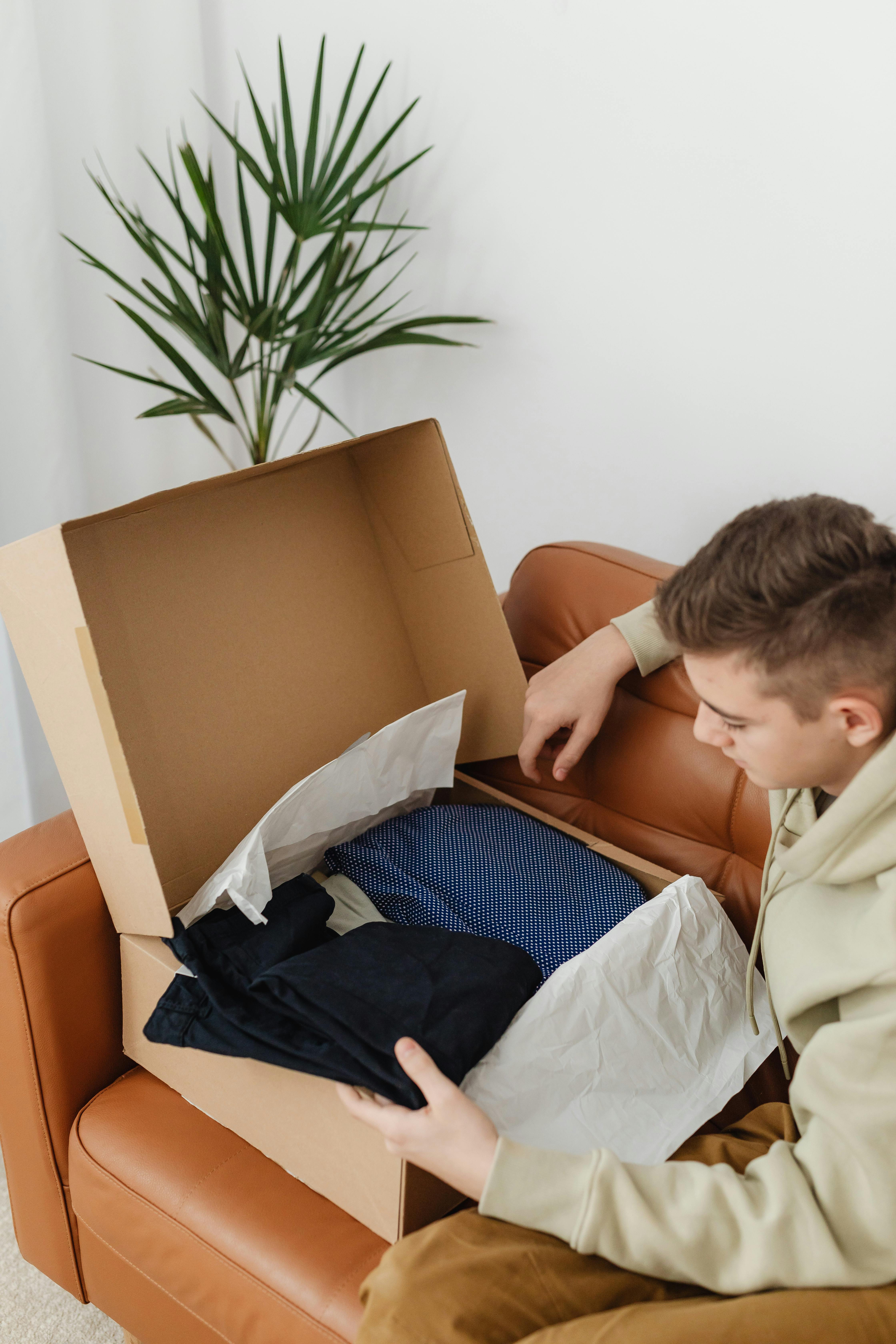 A boy looking at new clothes | Source: Pexels