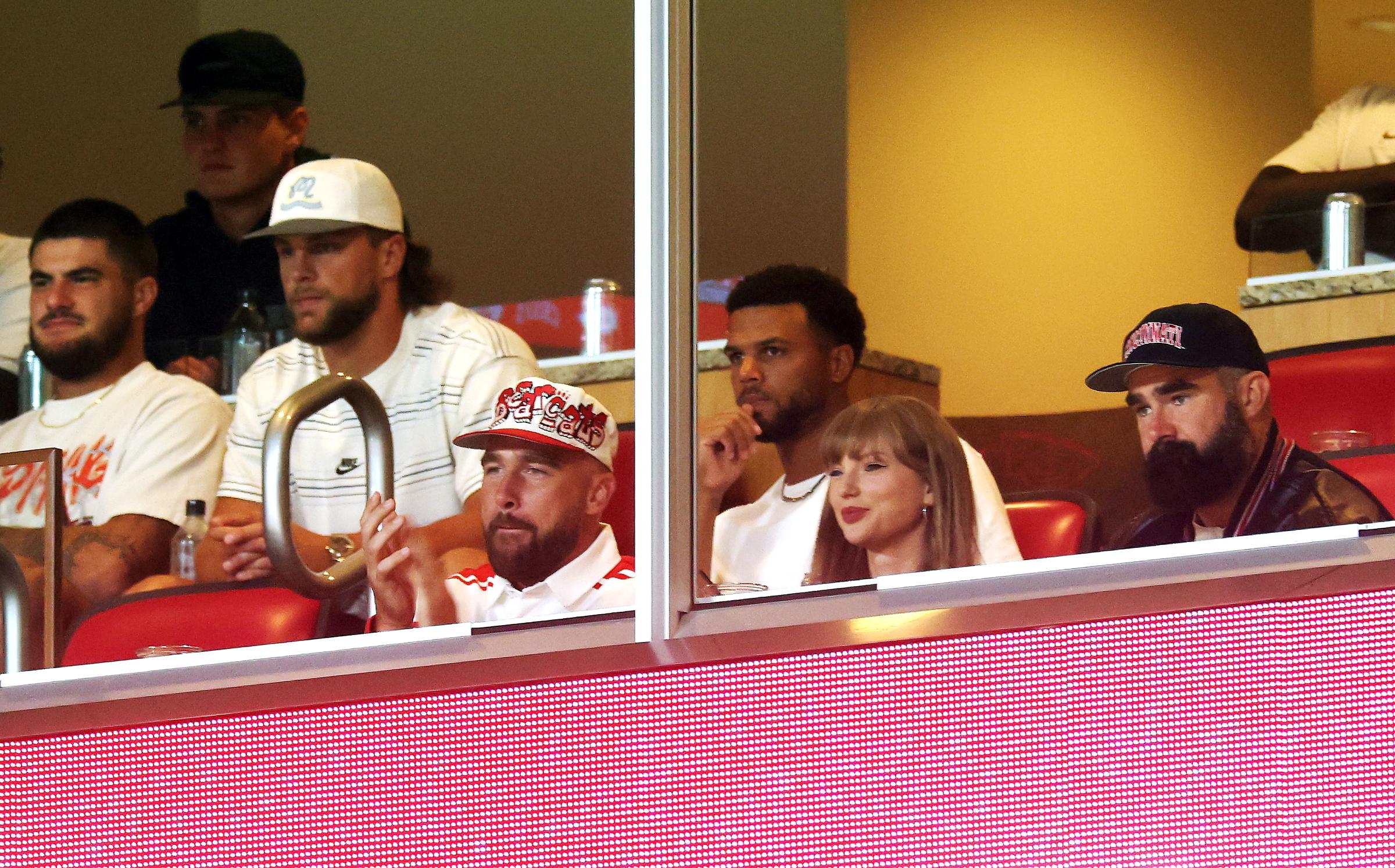 Travis Kelce, Taylor Swift, and Jason Kelce watch from a suite during the first half of the game between the Cincinnati Bearcats and the Nebraska Cornhuskers at Arrowhead Stadium on August 28, 2025, in Kansas City, Missouri. | Source: Getty Images