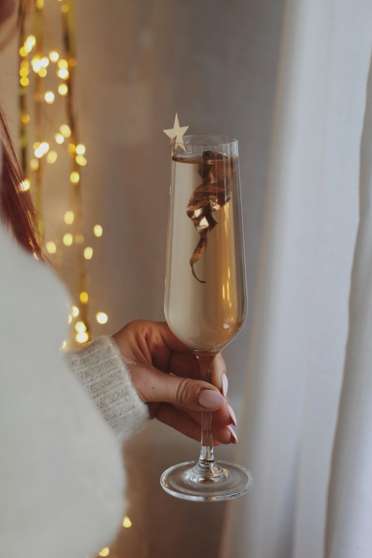 A woman holding a glass of champagne | Source: Pexels