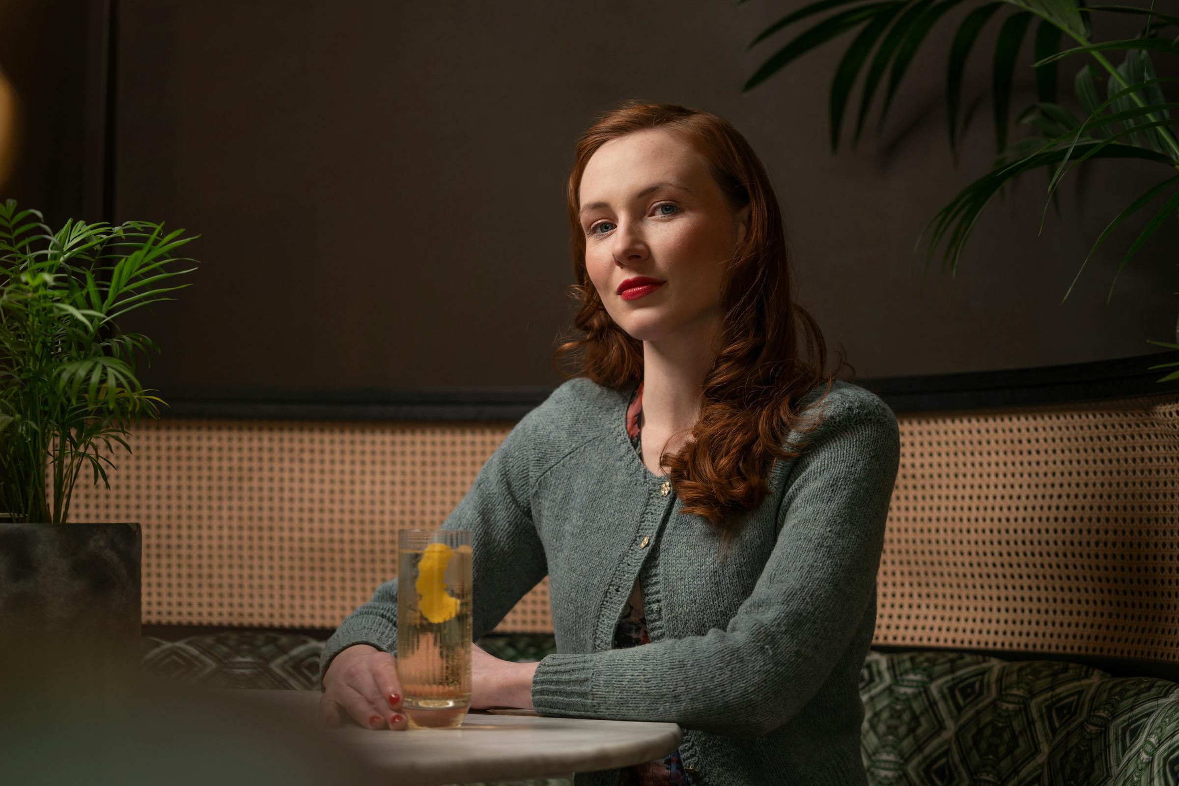 A smiling woman sitting at a table | Source: Unsplash
