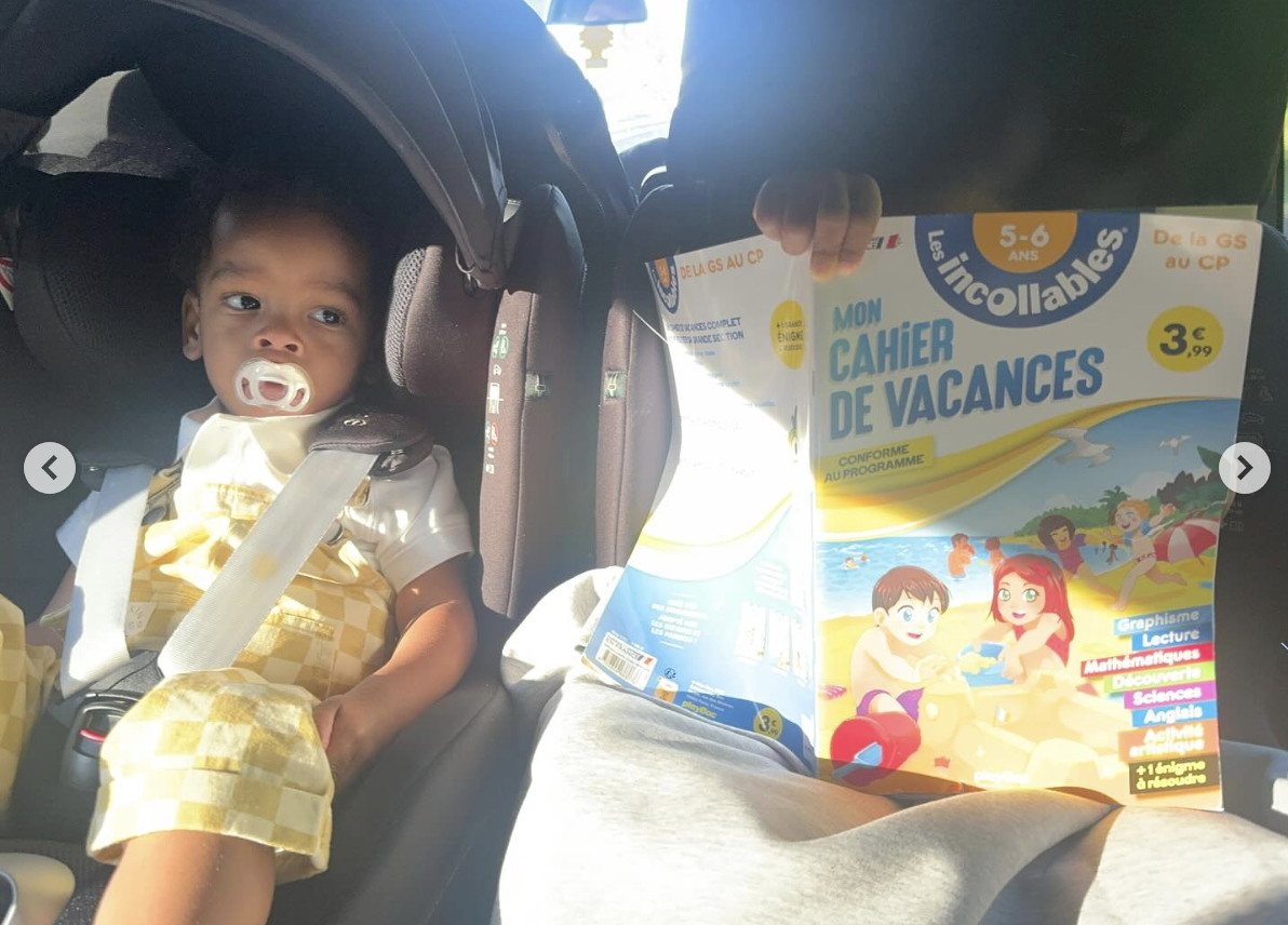 Riot Rose sits still while his brother RZA reads a French book, posted by Rihanna on July 3, 2025 | Source: Instagram/badgalriri