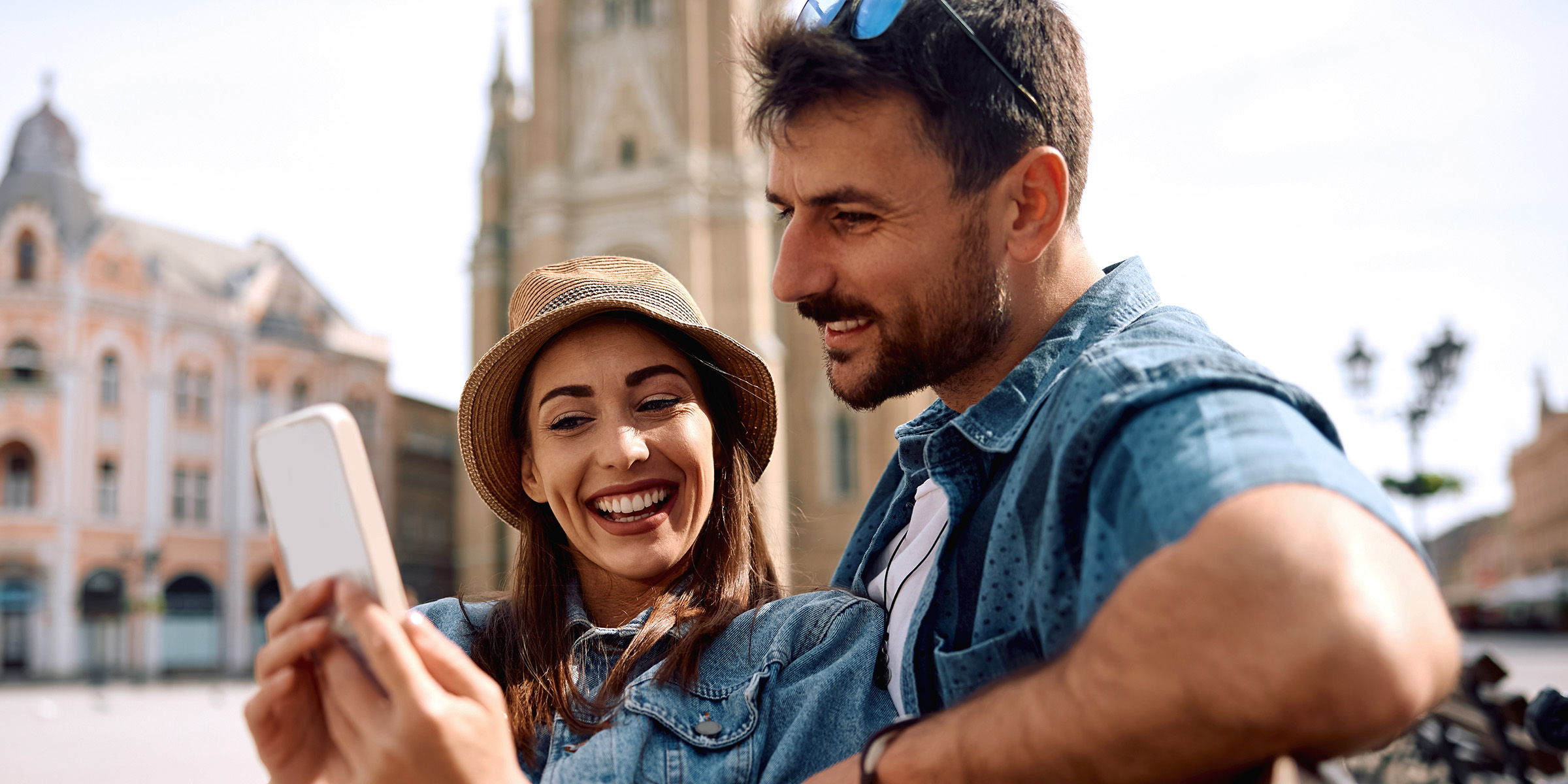 A couple looking at a smartphone | Source: Shutterstock