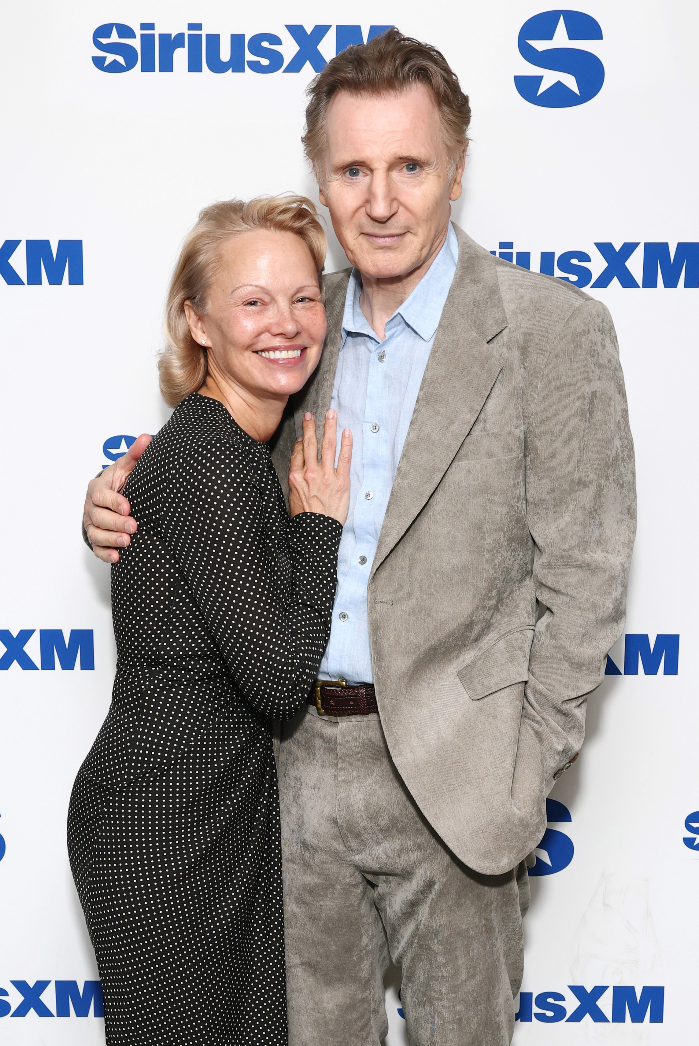 Pamela Anderson and Liam Neeson attend SiriusXM's Town Hall with the cast of "The Naked Gun" hosted by Andy Cohen at SiriusXM Studios on July 30, 2025, in New York City. | Source: Getty Images