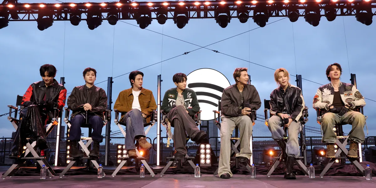 V, Suga, Jin, Jungkook, RM, Jimin and J-Hope of BTS speak onstage during Spotify x BTS: SWIMSIDE at Pier 17 on March 23, 2026 in New York City. | Source: Getty Images