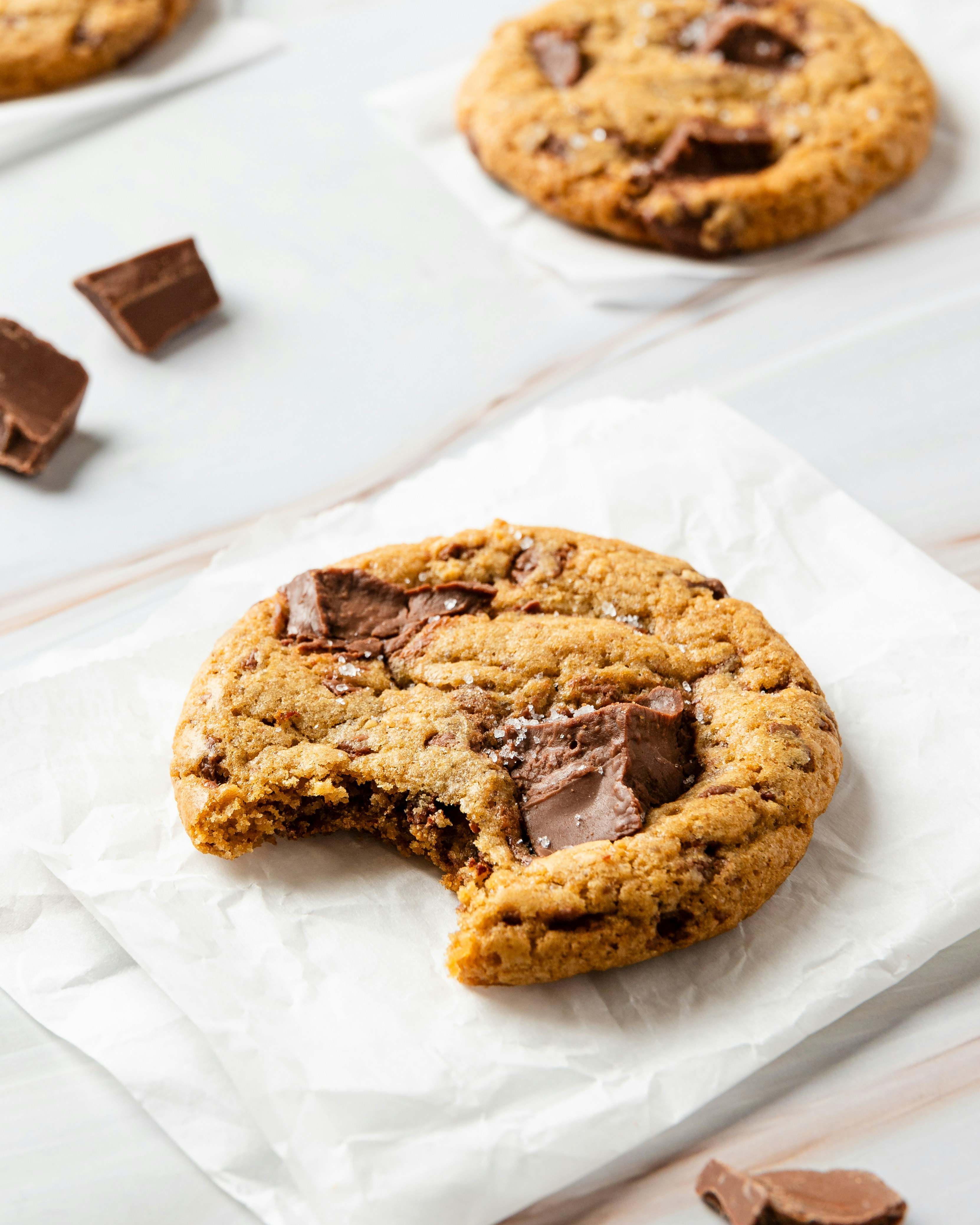 A chocolate chip cookie with a bite taken out | Source: Unsplash