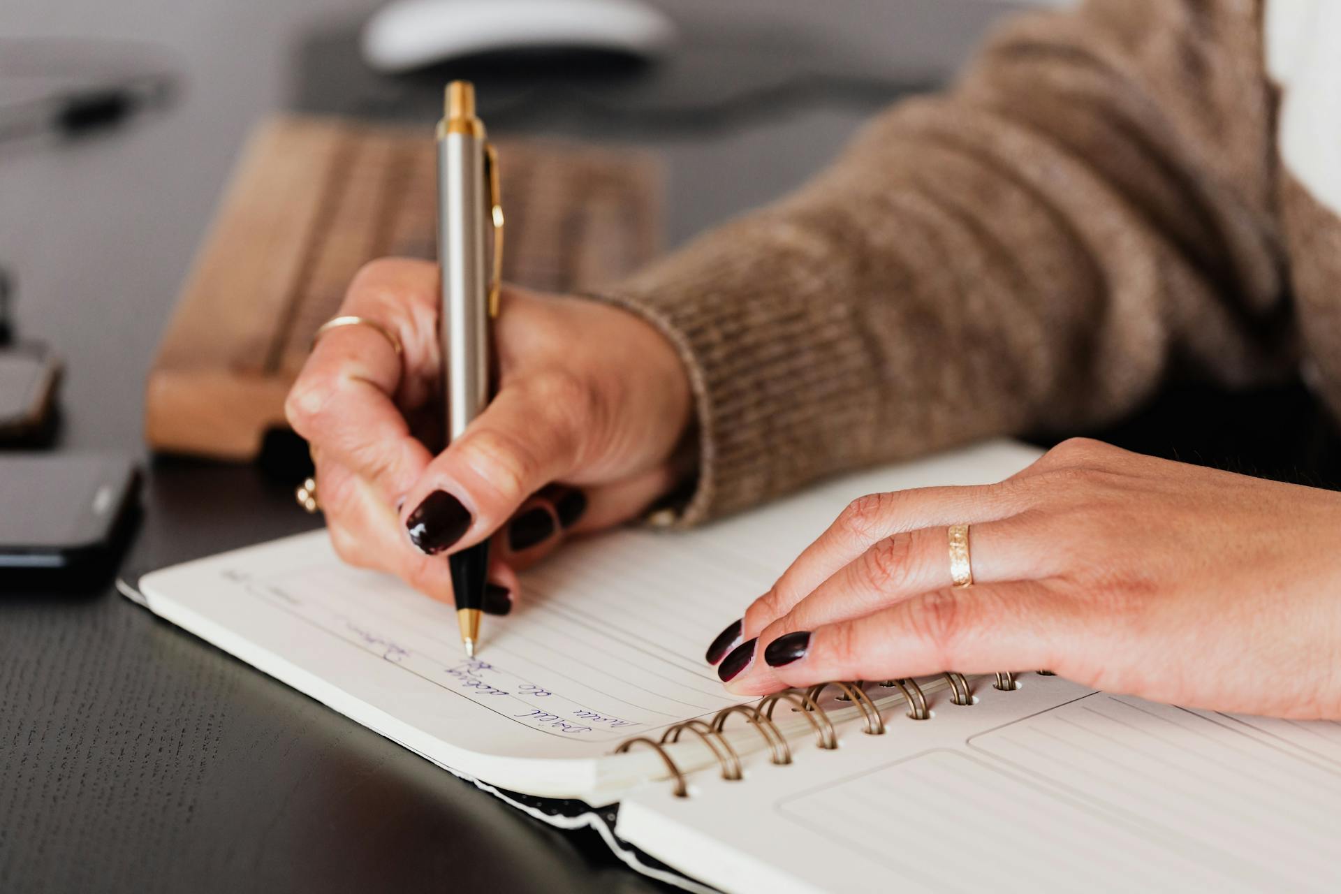 A woman writing in a notebook | Source: Pexels