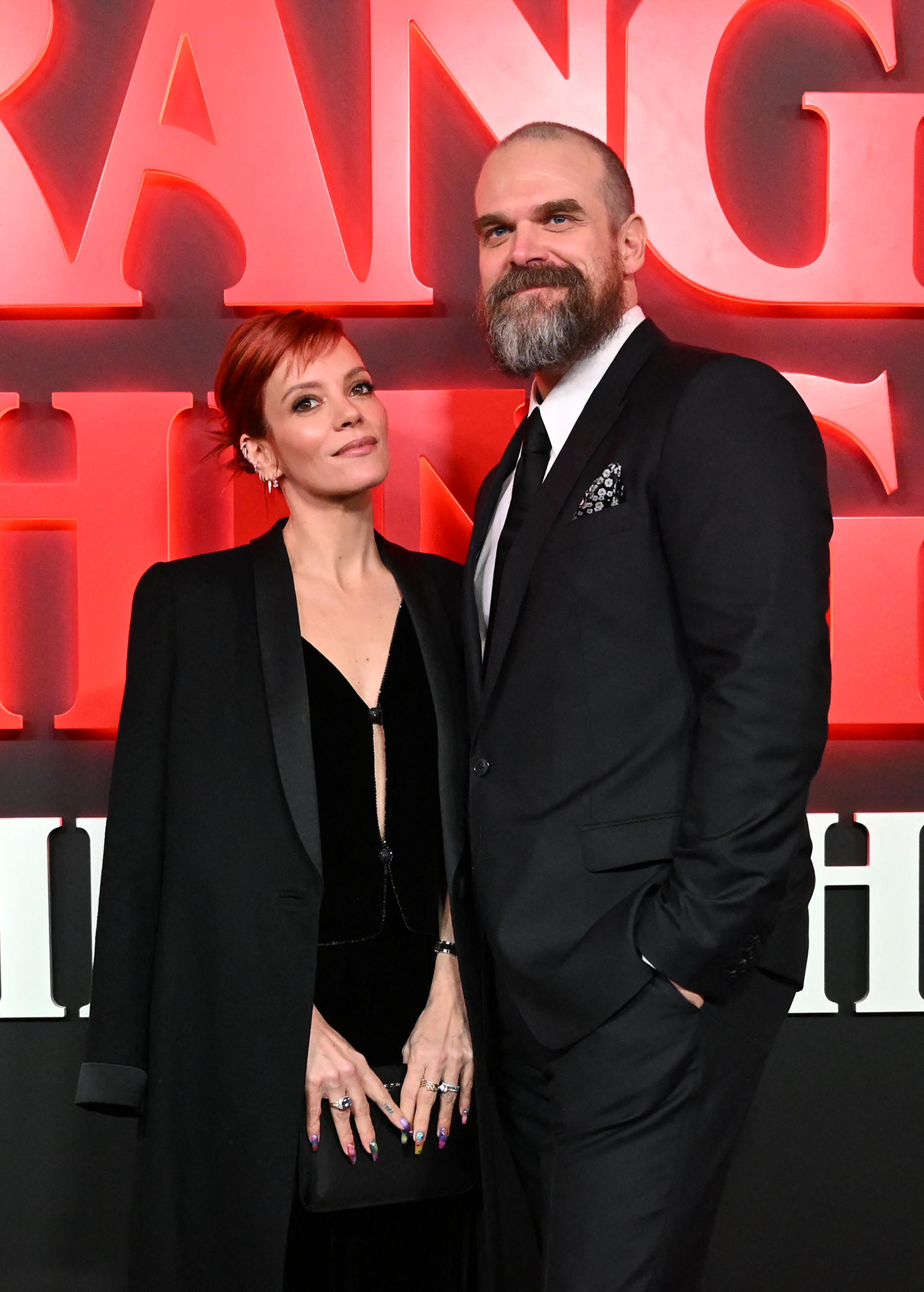 Lily Allen and David Harbour pose on the red carpet upon arrival to attend the West End world premiere of "Stranger Things: The Last Shadow" stage play at the Phoenix Threatre on December 14, 2023 in central London, England. | Source: Getty Images