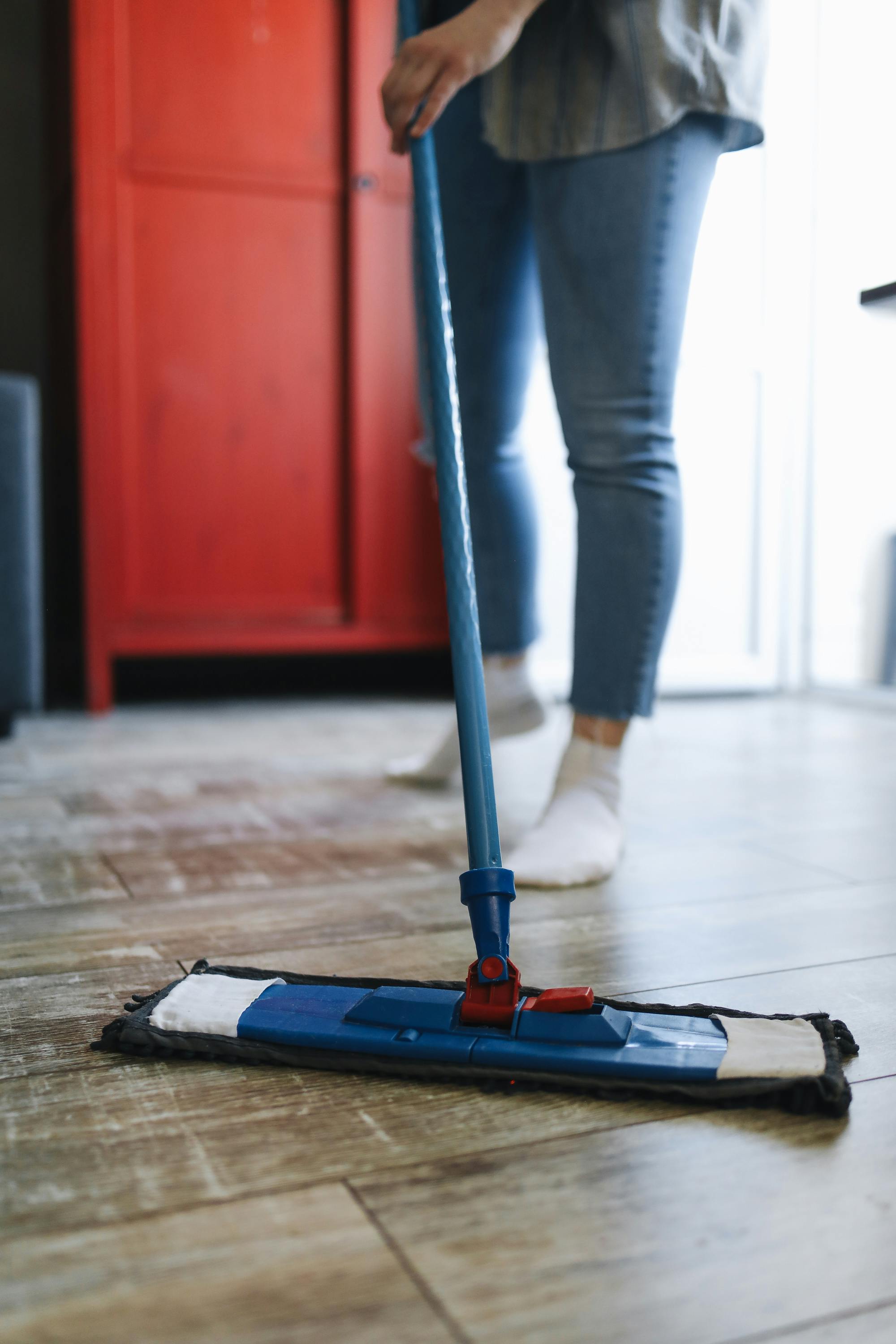 A woman mopping the floor | Source: Pexels