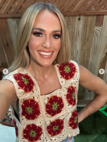 Carrie Underwood poses in her tomato top, dated May 2025 | Source: Instagram/carrieunderwood