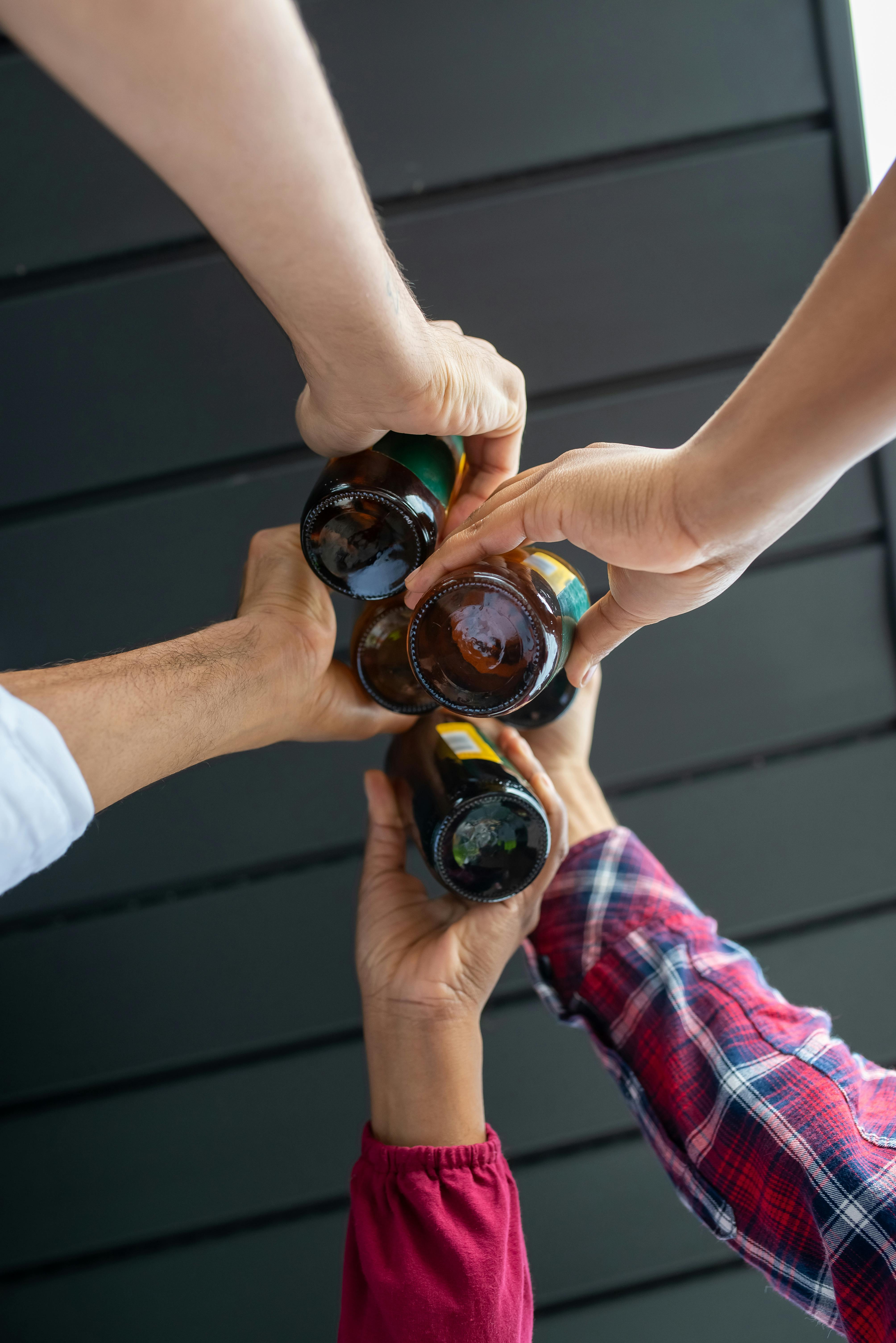 Drinks raised for a toast | Source: Pexels