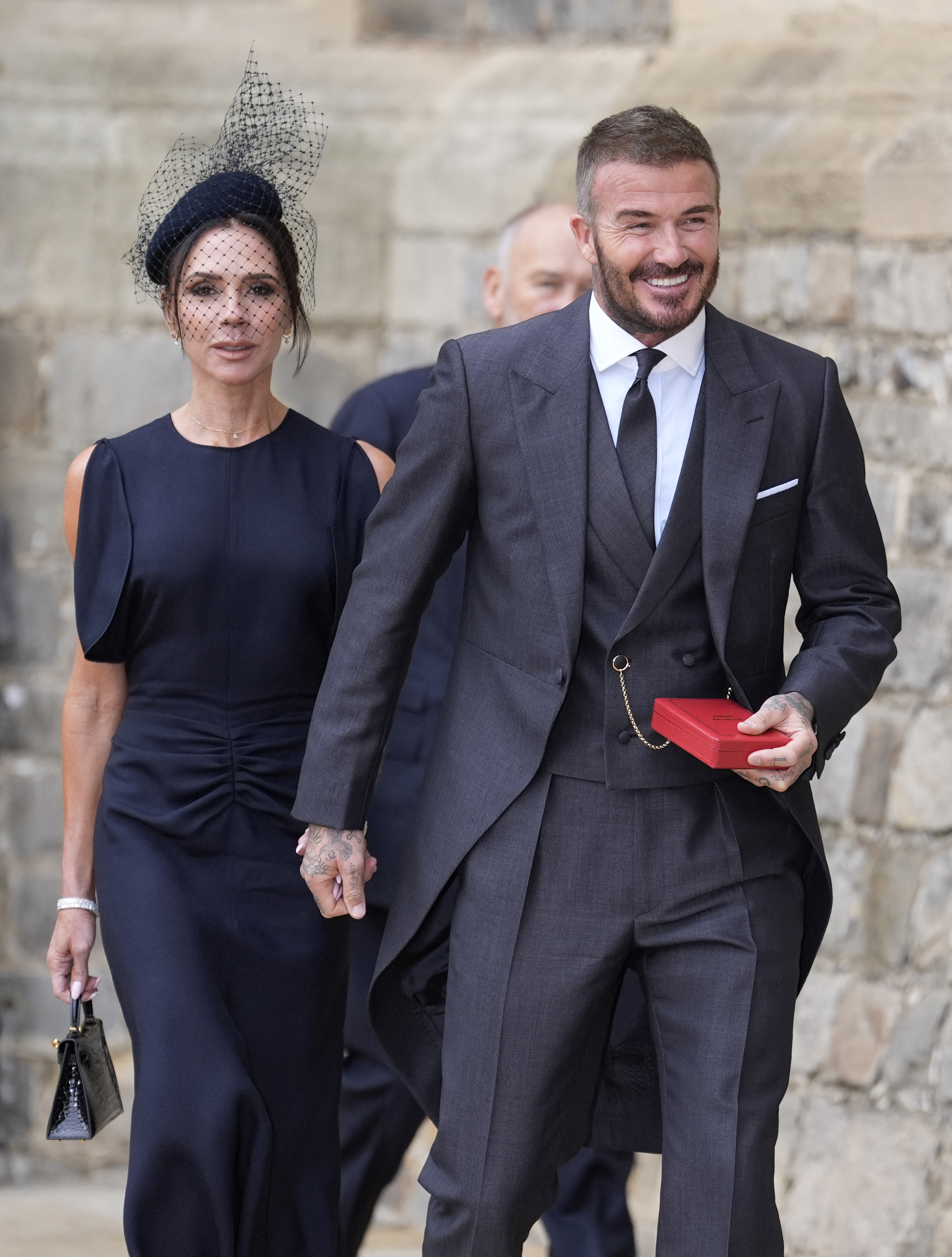 Sir David Beckham walks with his wife, Lady Victoria Beckham, after he was made a Knight Bachelor at an investiture ceremony at Windsor Castle on November 4, 2025, in Windsor, England. | Source: Getty Images