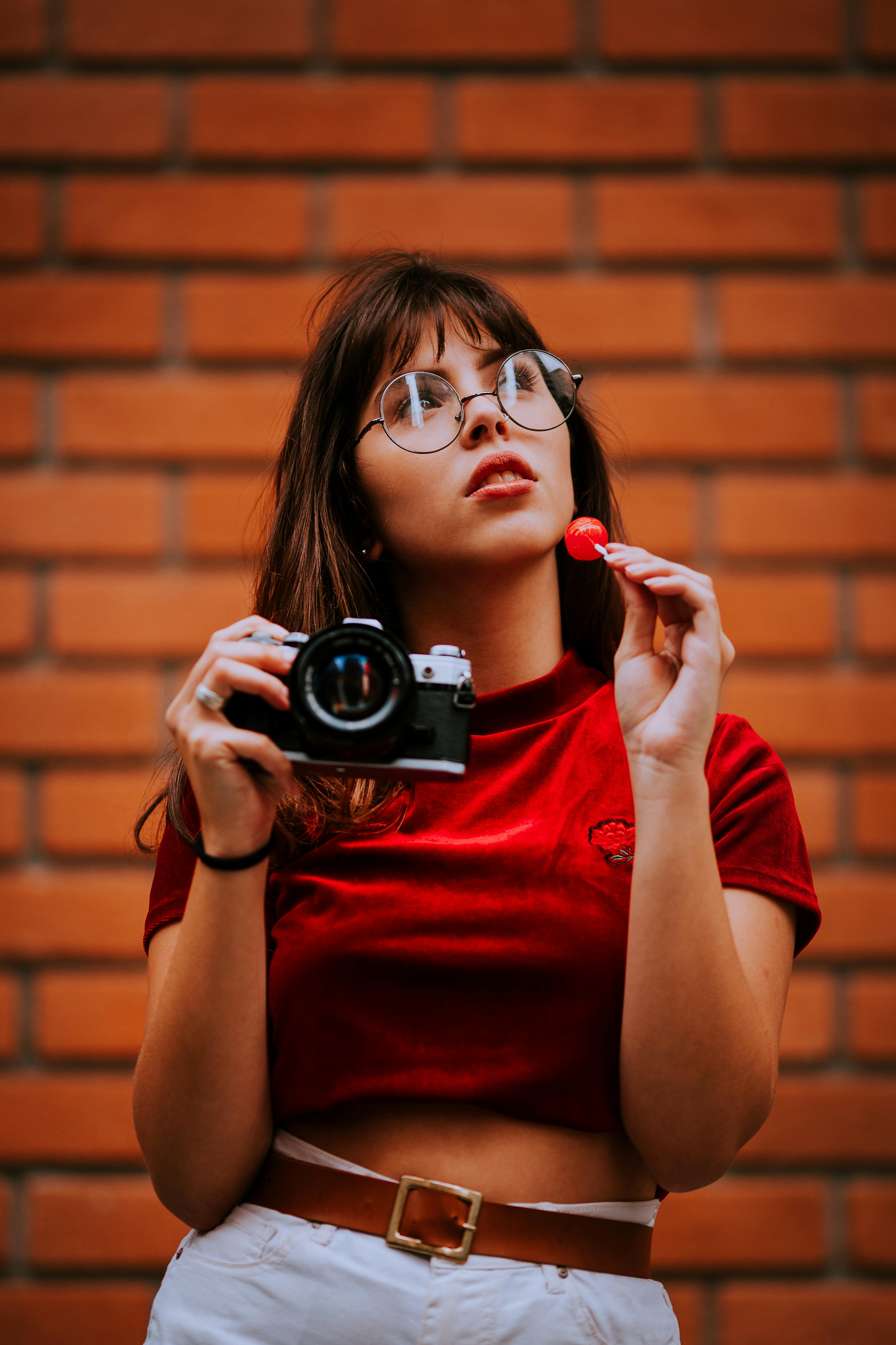 A young woman holding a camera | Source: Pexels