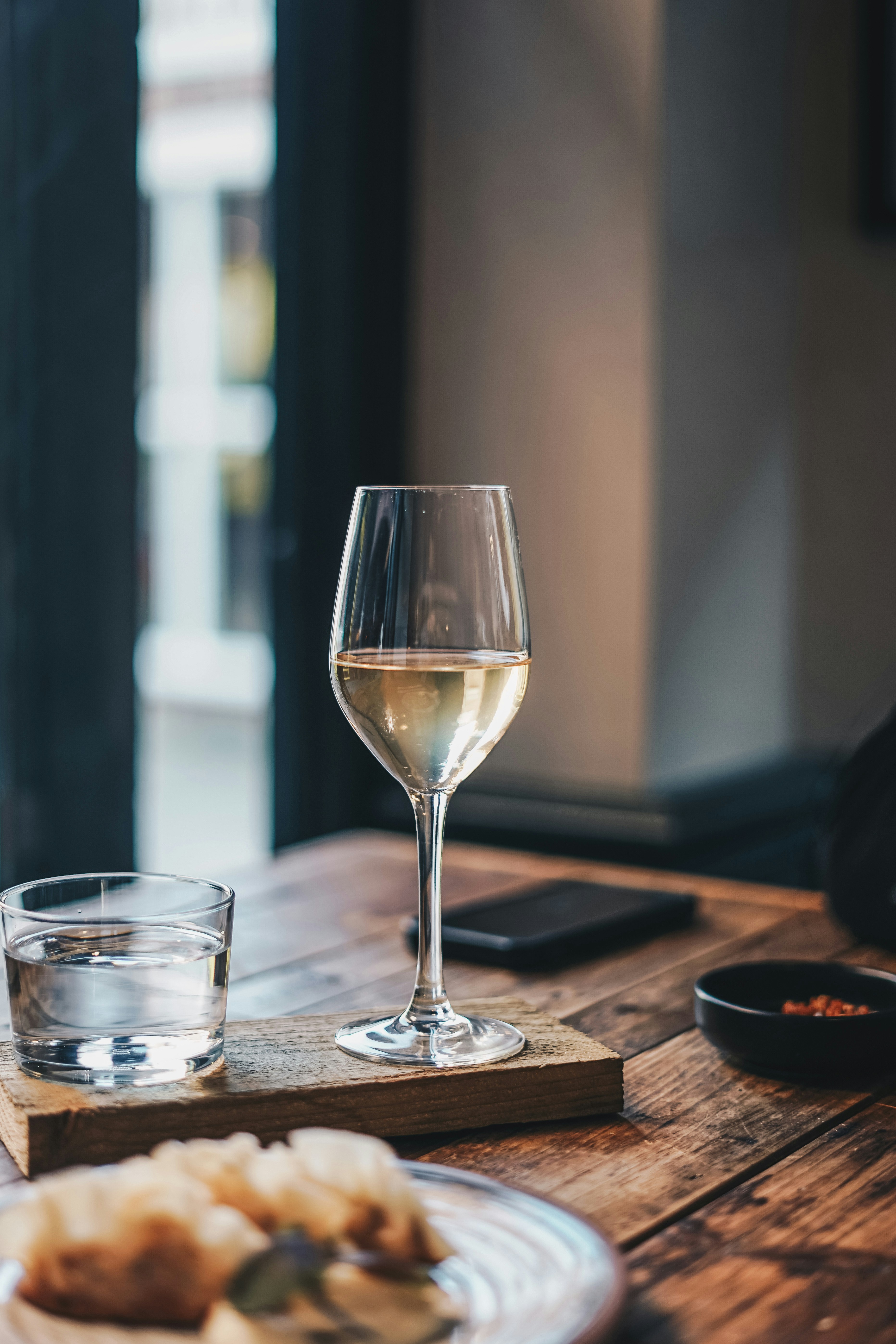 A glass of wine on a table | Source: Unsplash