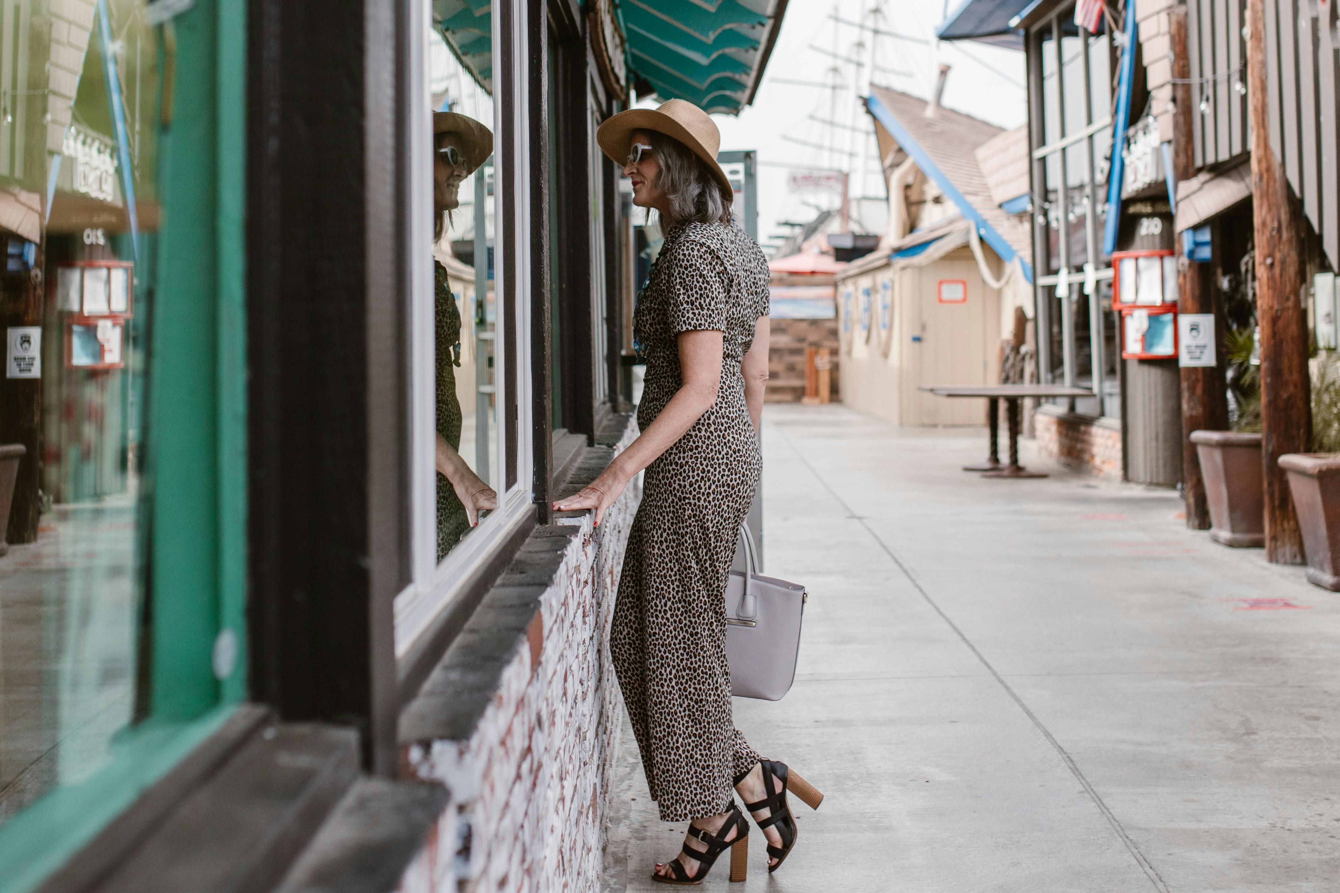 Woman standing outside a shop, looking through the windows | Source: Pexels