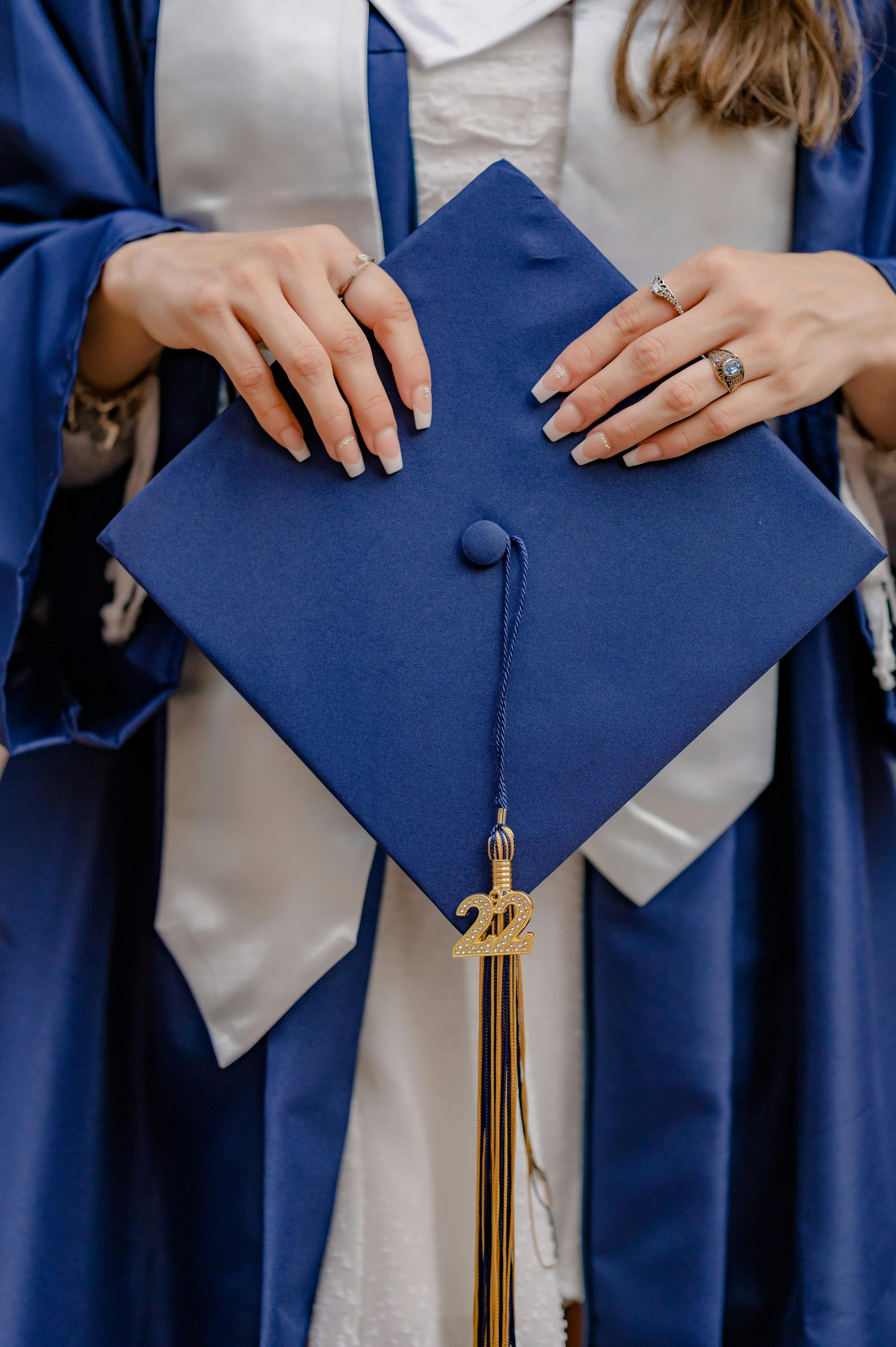 A woman holding her graduation cap | Source: Pexels