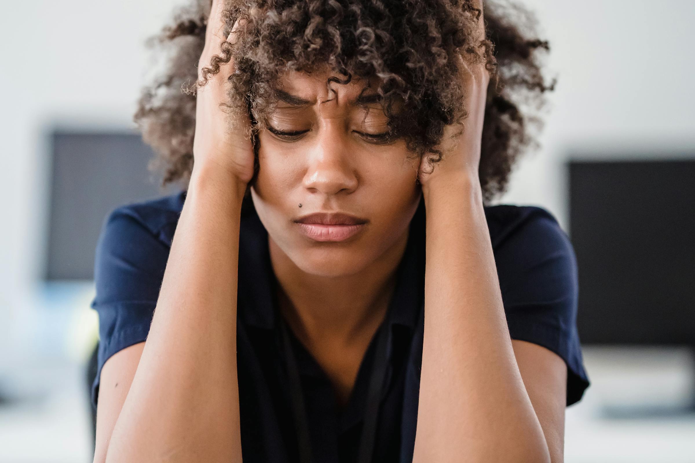 A woman leaning on a table looking worried | Source: Pexels