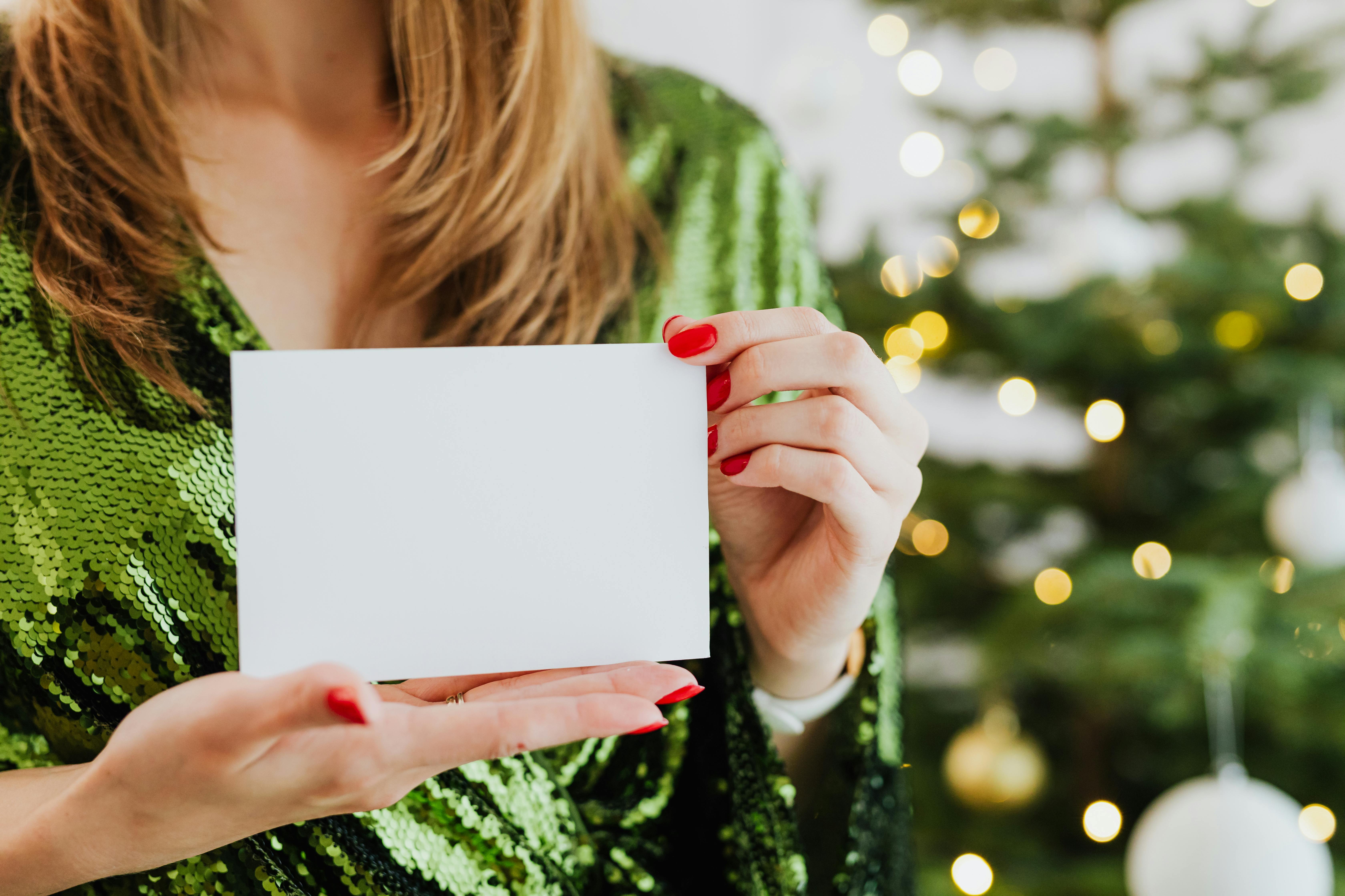 A woman holding an envelope | Source: Pexels