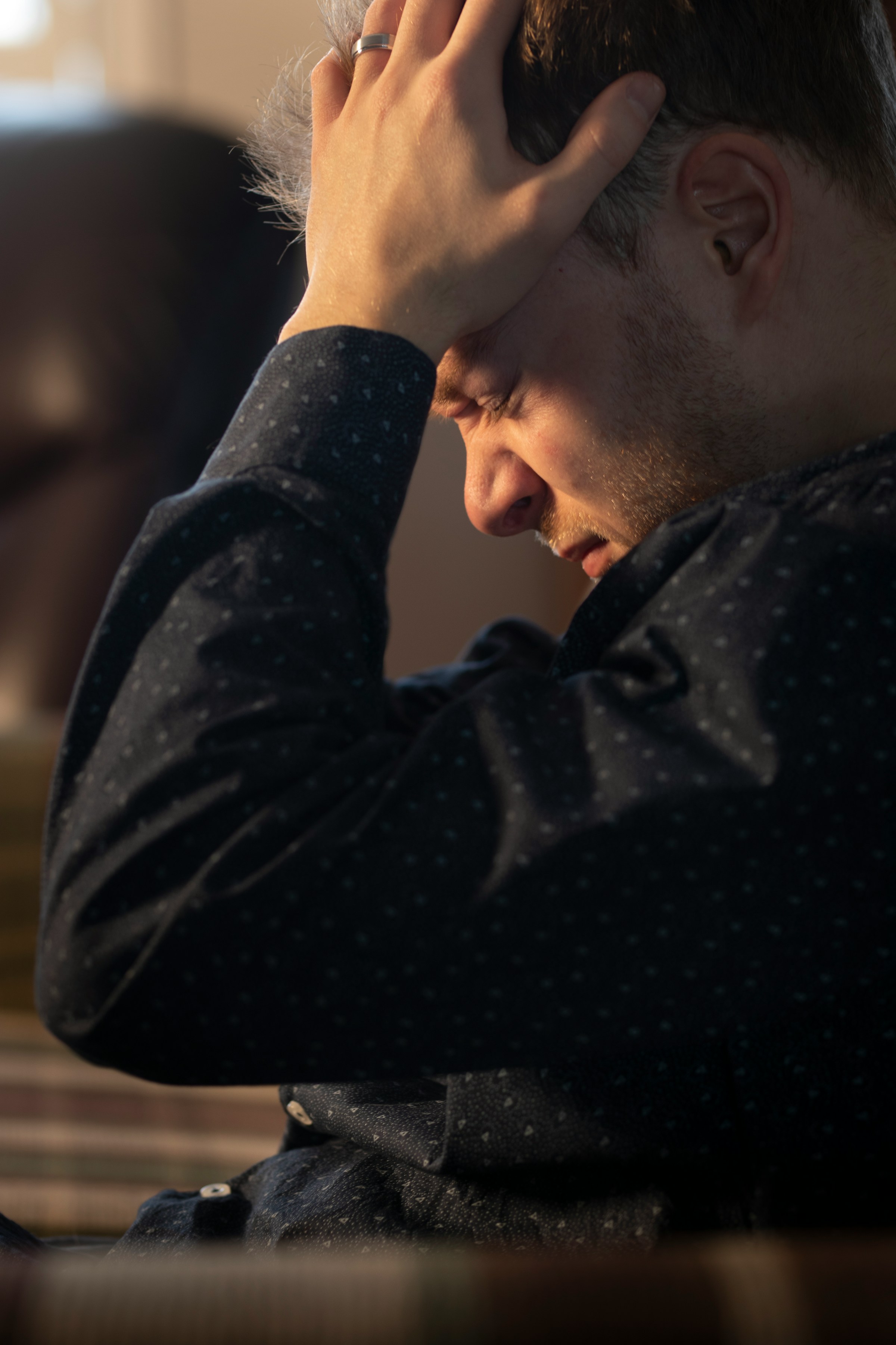 A distressed man with his hands on his head | Source: Unsplash